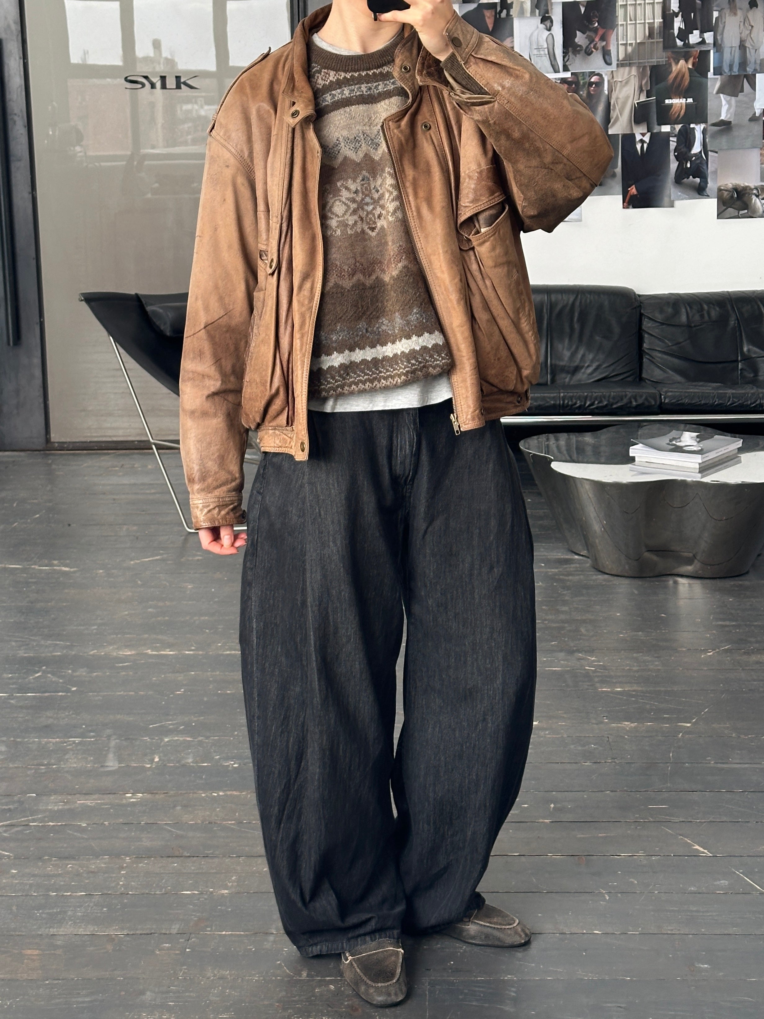 Vintage 1990s high neck aged leather bomber jacket with distressed finish, displayed on a hanger.