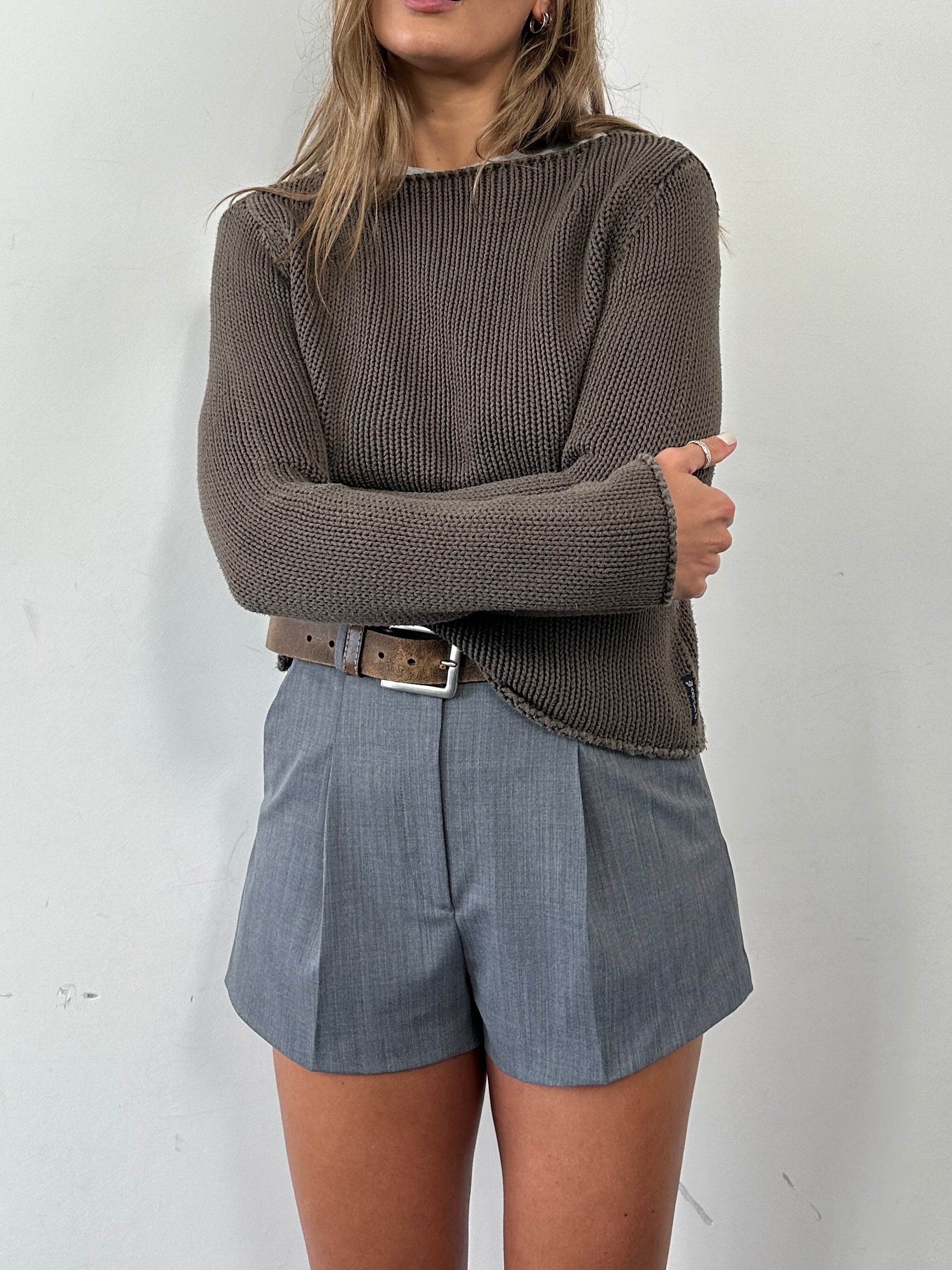 Armani Jeans cropped knitted jumper in pure cotton, displayed on a hanger, featuring a relaxed fit and ribbed cuffs.