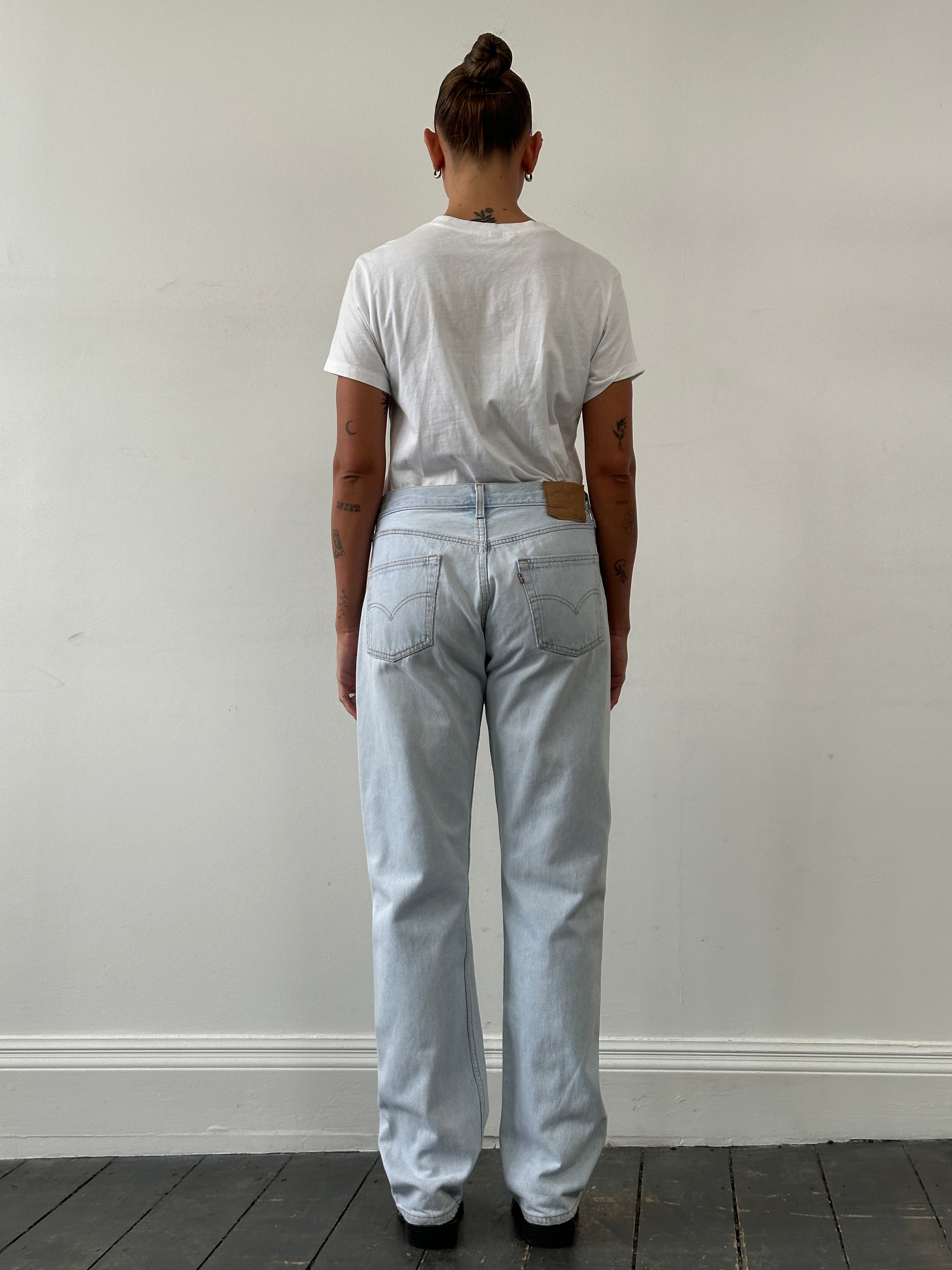 Levi’s 501 light wash straight leg denim jeans, W30, showing the classic fit and clean front with belt loops and pockets.