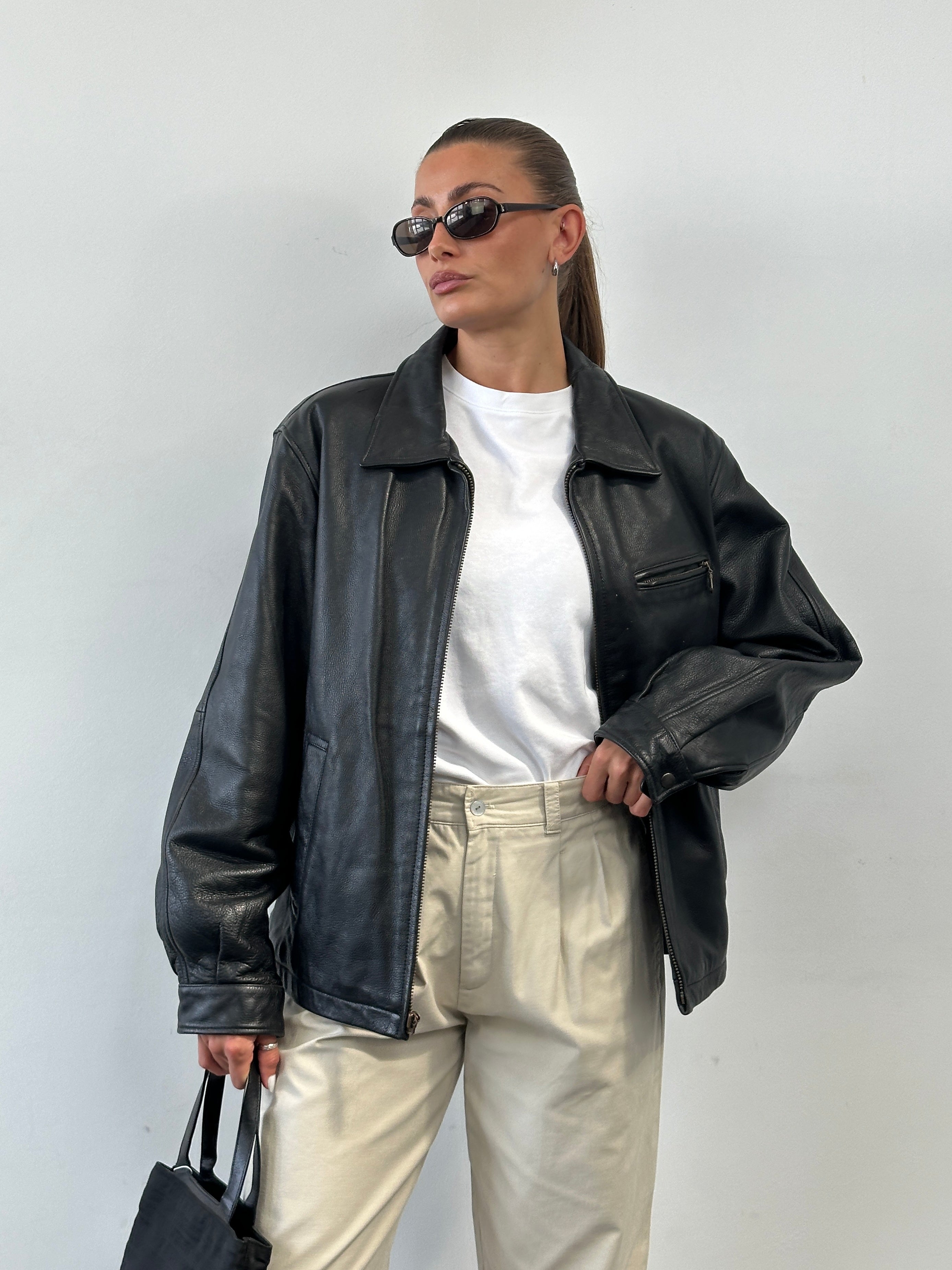 Vintage minimal leather jacket in size L, featuring a classic design with smooth leather and clean lines.