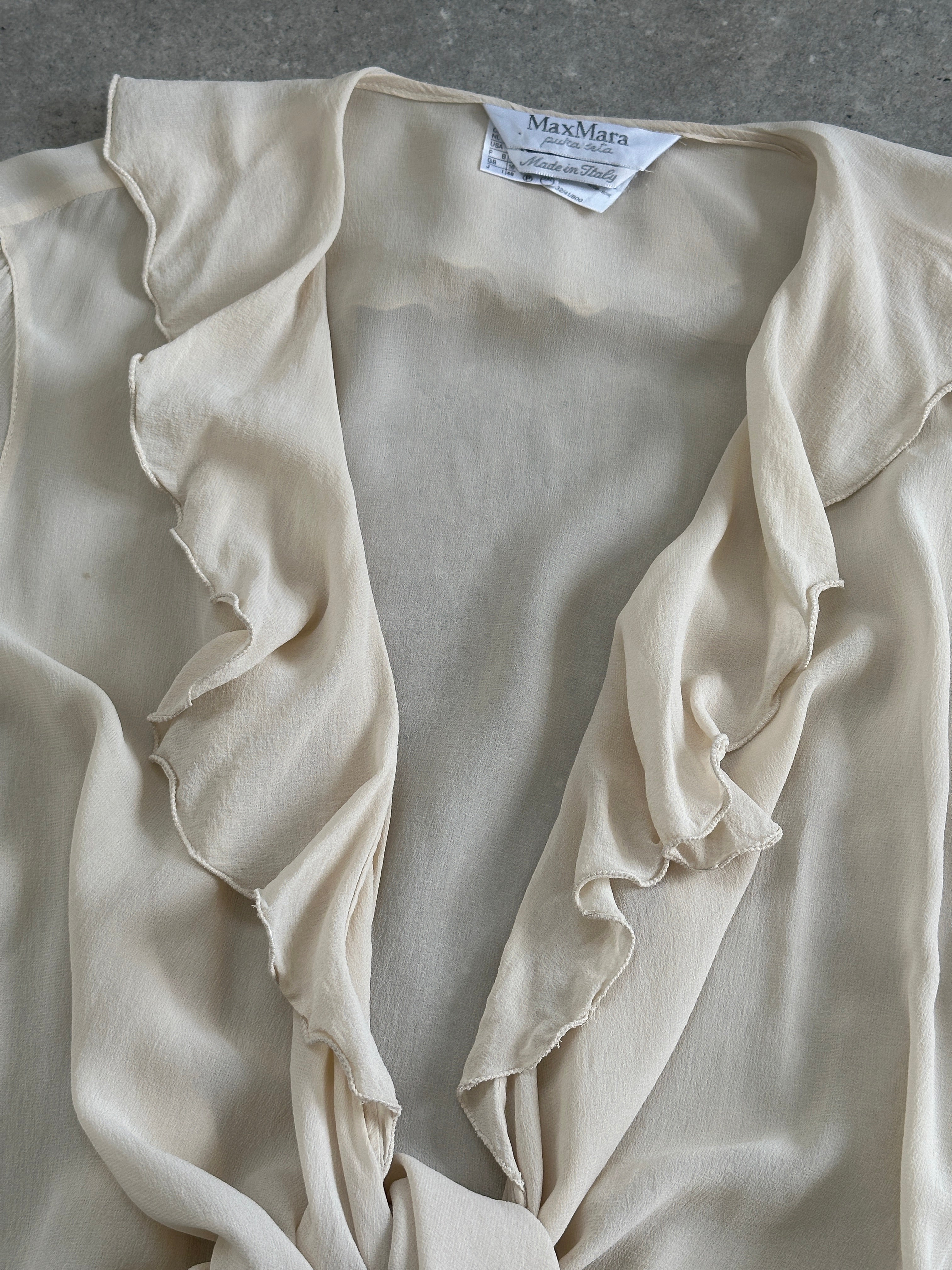 Max Mara pure silk frill wrap blouse in size L, featuring elegant draped fabric and ruffled details, styled with long sleeves.