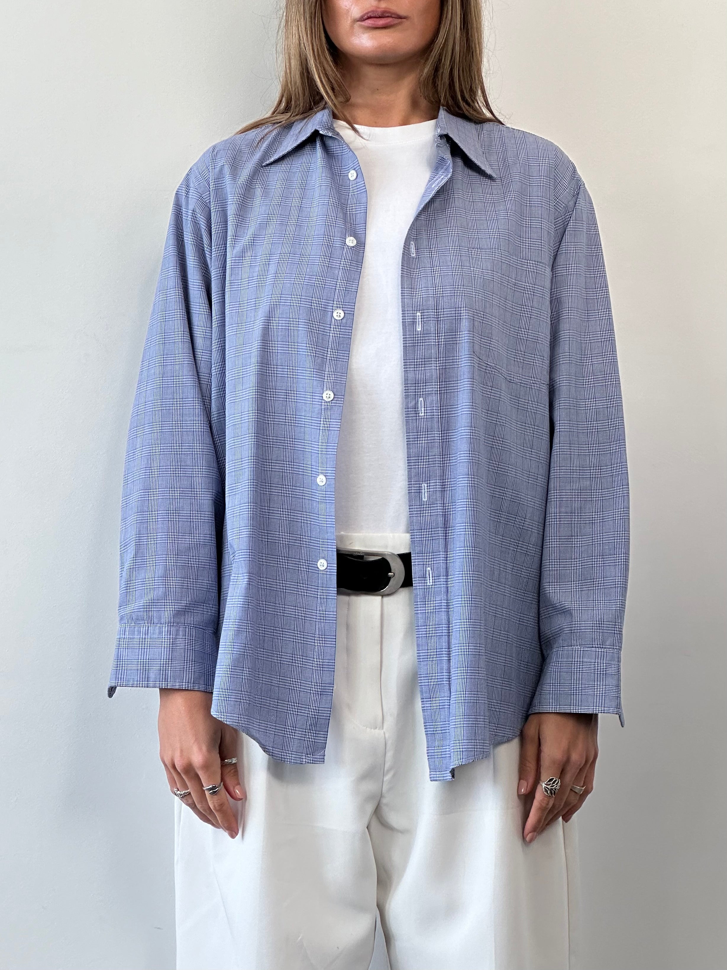 Christian Dior cotton check shirt in size L displayed on a hanger, featuring classic pattern and tailored fit.