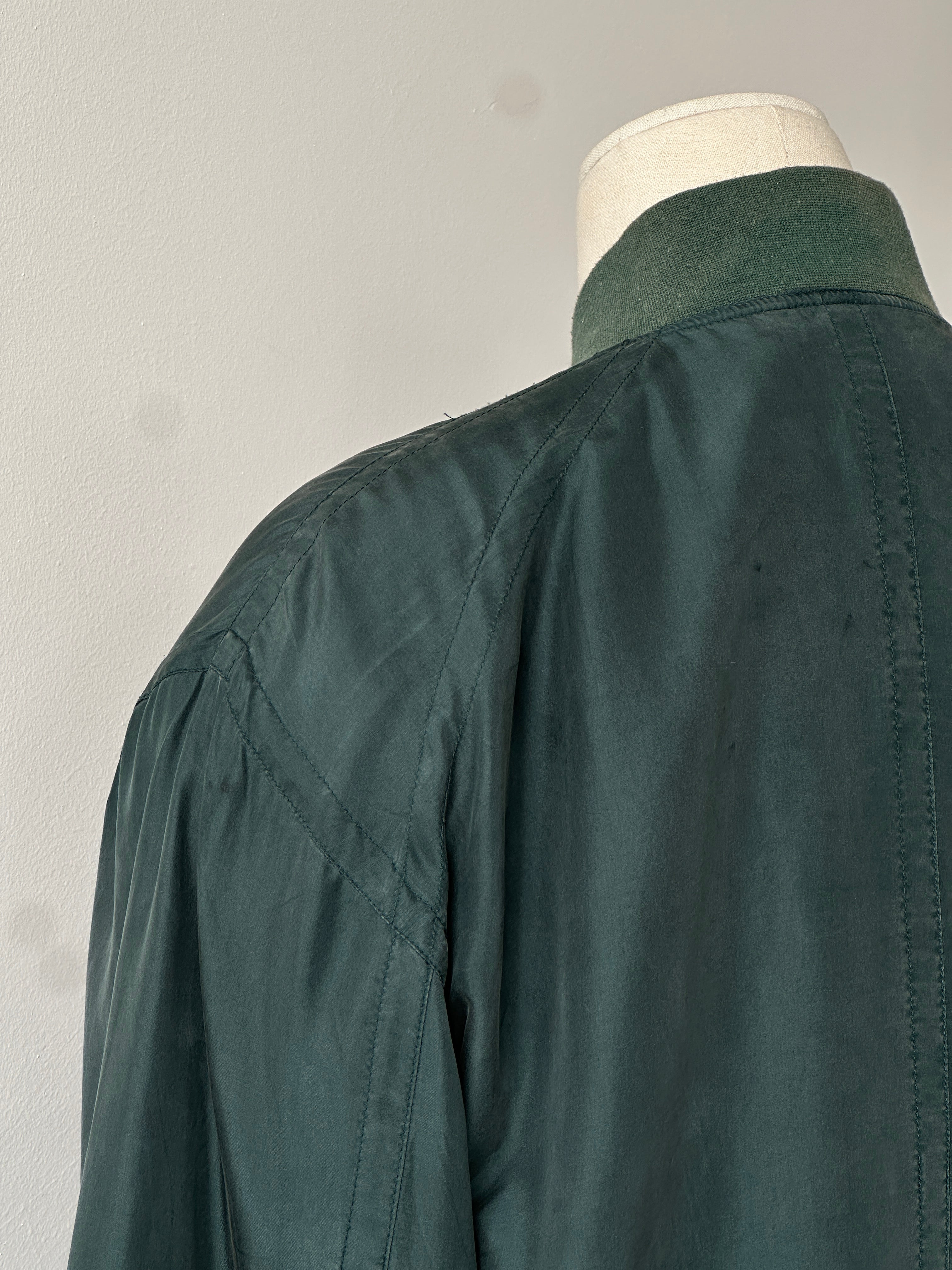 Vintage 1990s pure silk bomber jacket in size M, featuring a classic design with a smooth, shiny silk finish and ribbed collar.