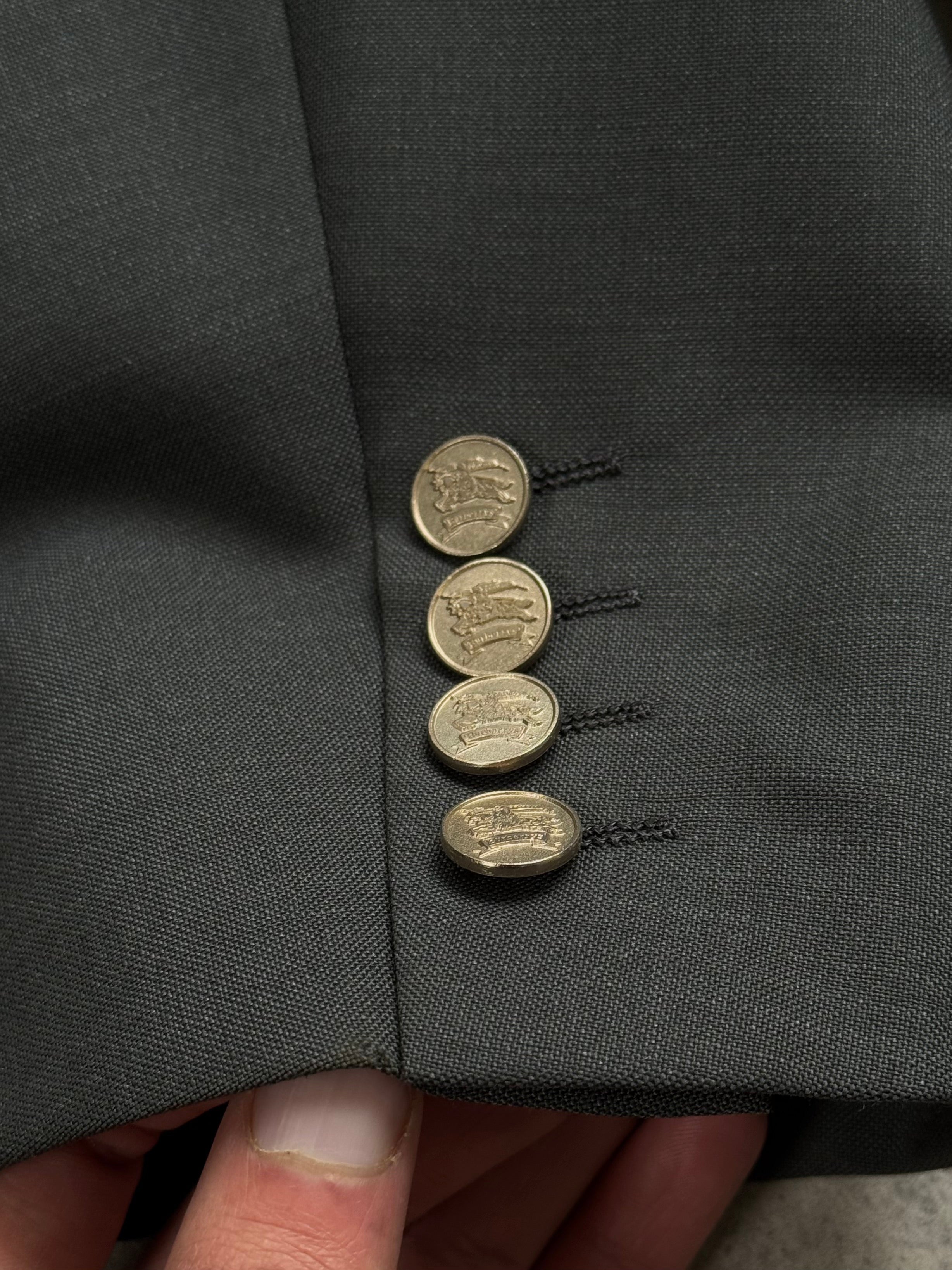 Burberry 1990s wool mohair double-breasted blazer in XL, featuring classic design and textured fabric, shown on a hanger.