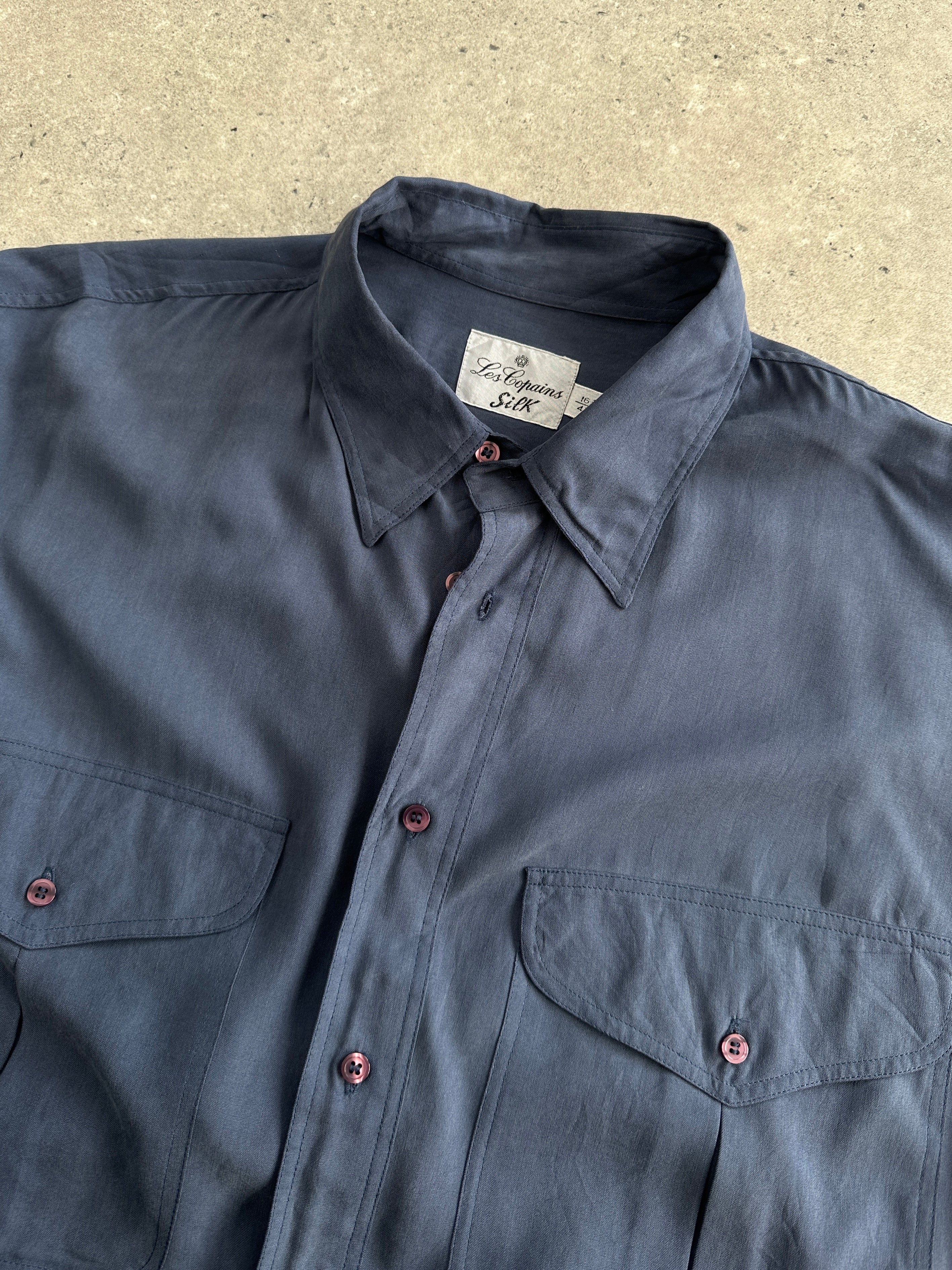 Vintage pure silk shirt in XL, featuring a smooth, luxurious fabric and classic design, displayed on a hanger.