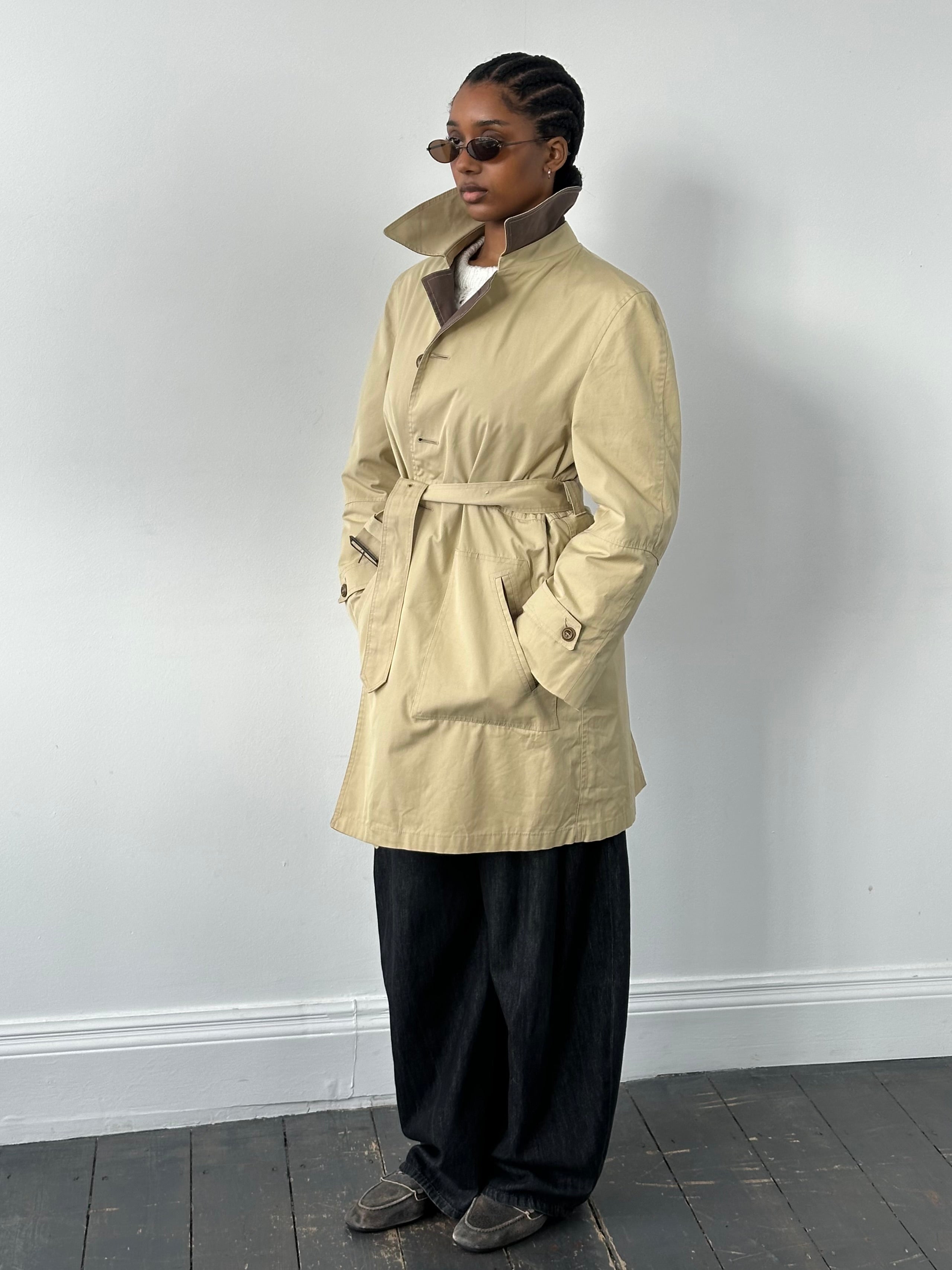 Christian Dior Paris 1980s cotton belted trench coat, mid-length with classic collar and stylish design, shown on model.