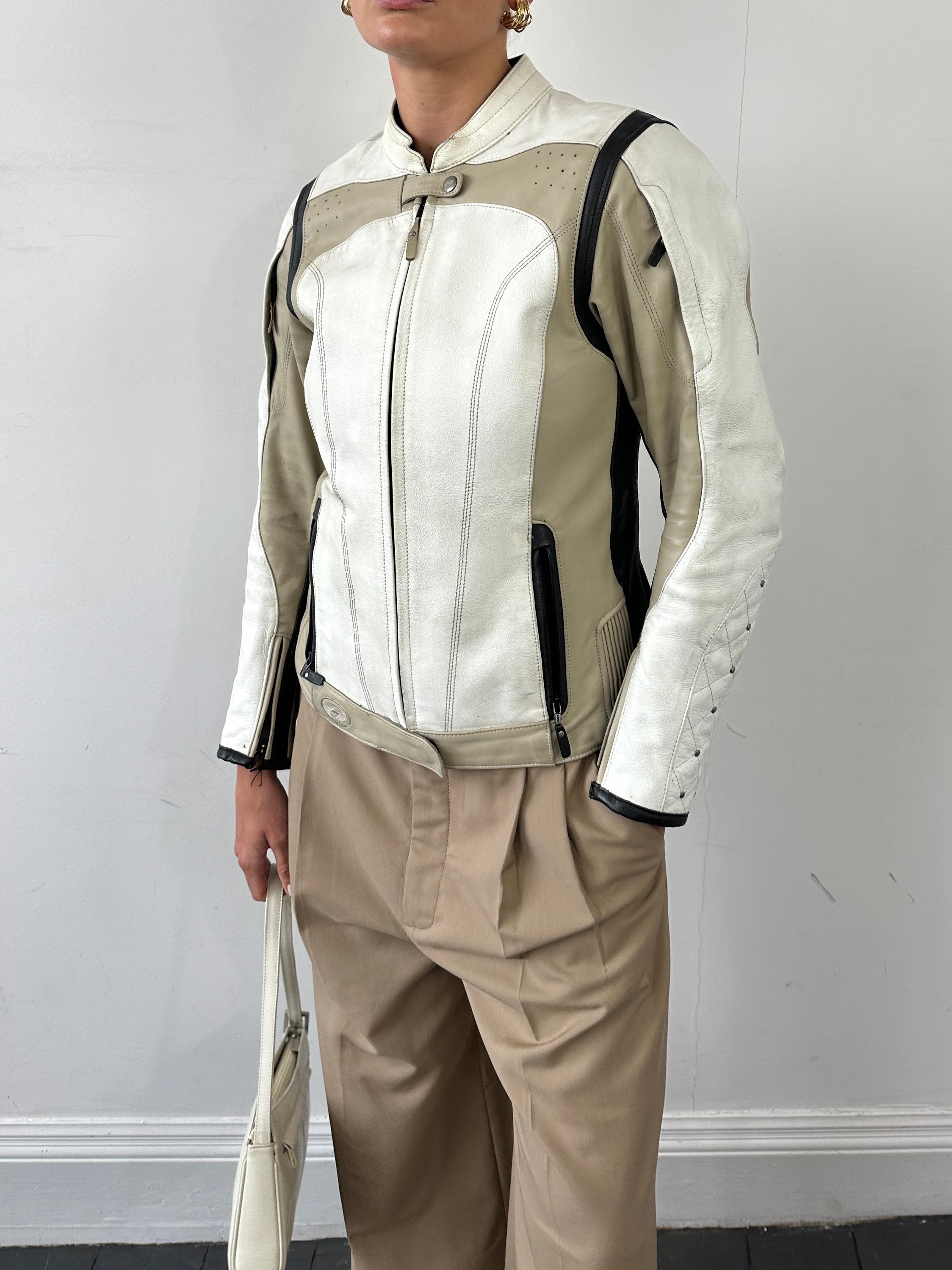 Vintage leather motorcycle jacket in size small/medium, featuring classic design and durable leather construction.