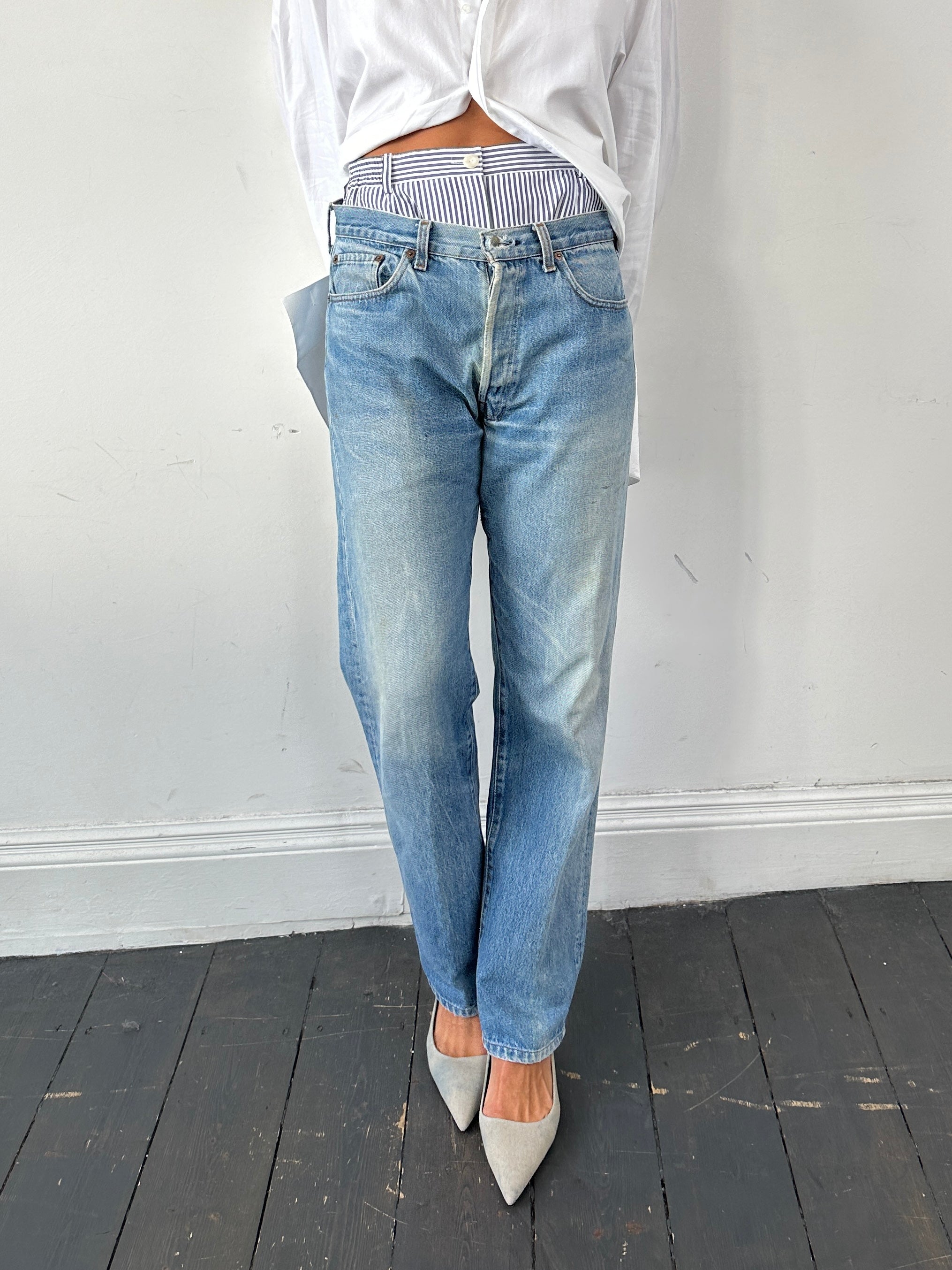Levi's 501 straight leg denim jeans in W32, showing classic blue denim with a button fly and five-pocket design.