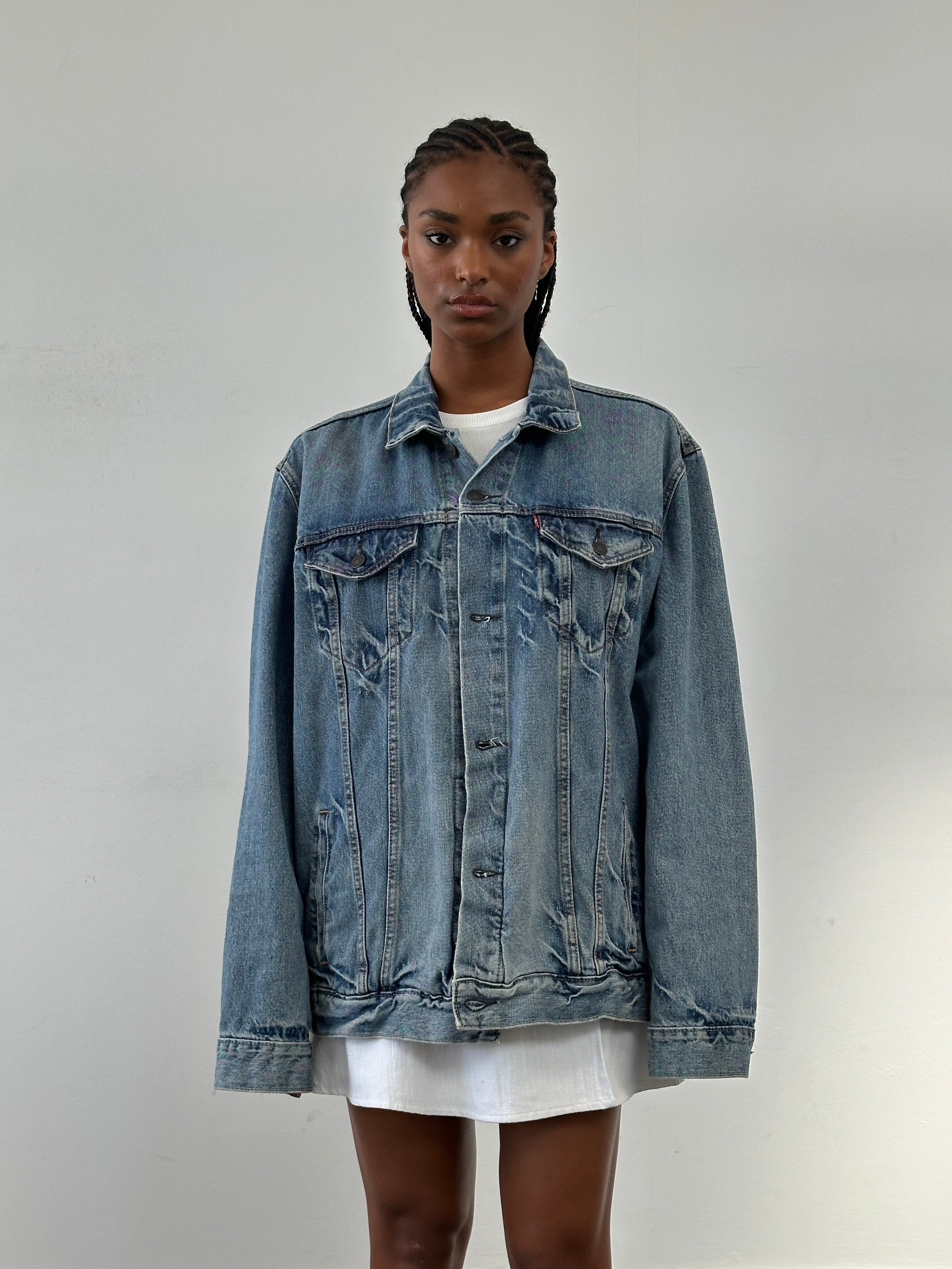 Levi’s 2000s light wash denim jacket in size XL with classic styling and button-front closure, shown on a hanger.