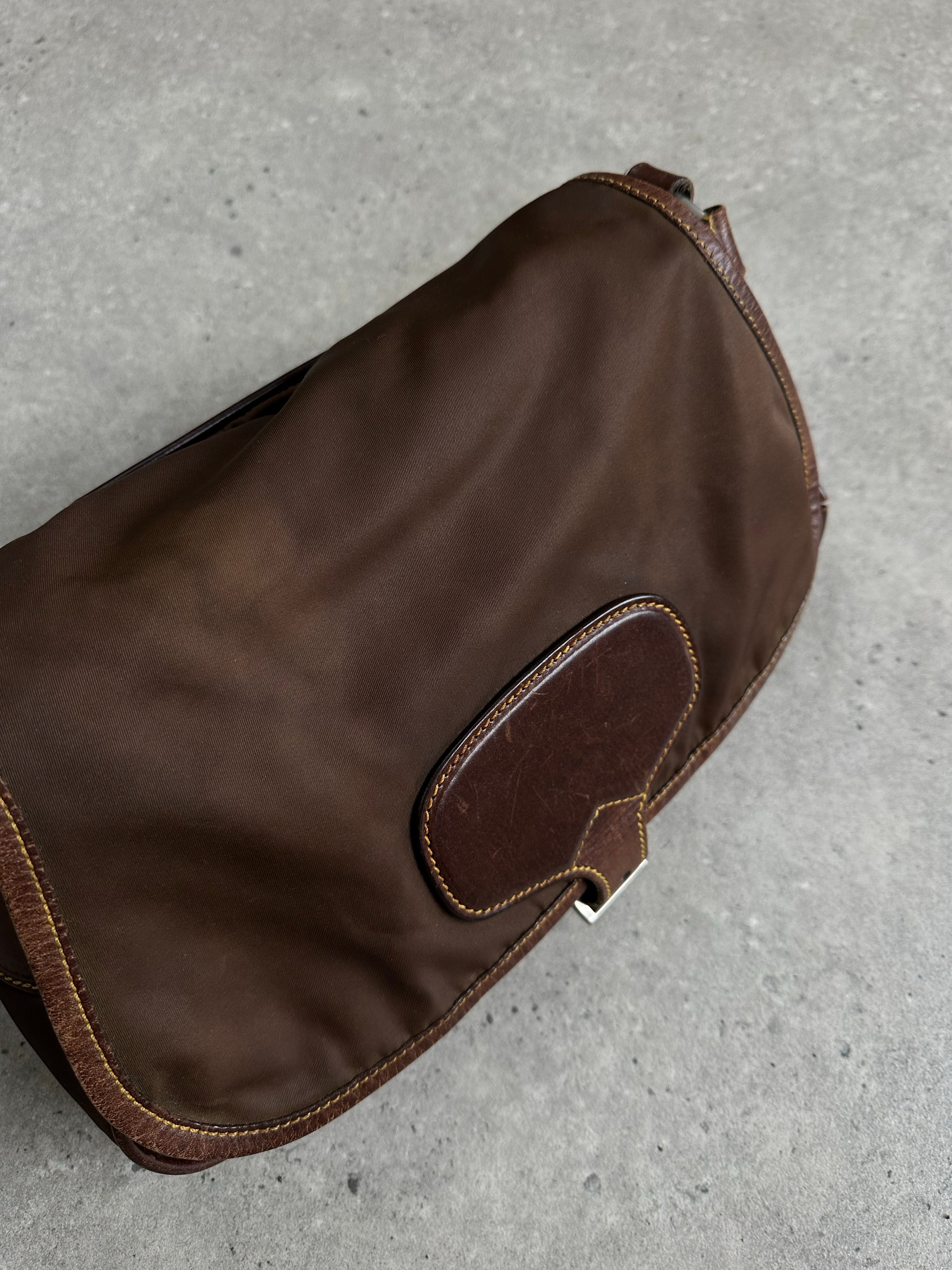 Prada 1990s nylon crossbody bag with adjustable strap and sleek design, featuring the iconic Prada logo and durable nylon material.