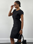 Italian vintage sleeveless pleated midi dress with a fitted bodice and flowing skirt in classic style.