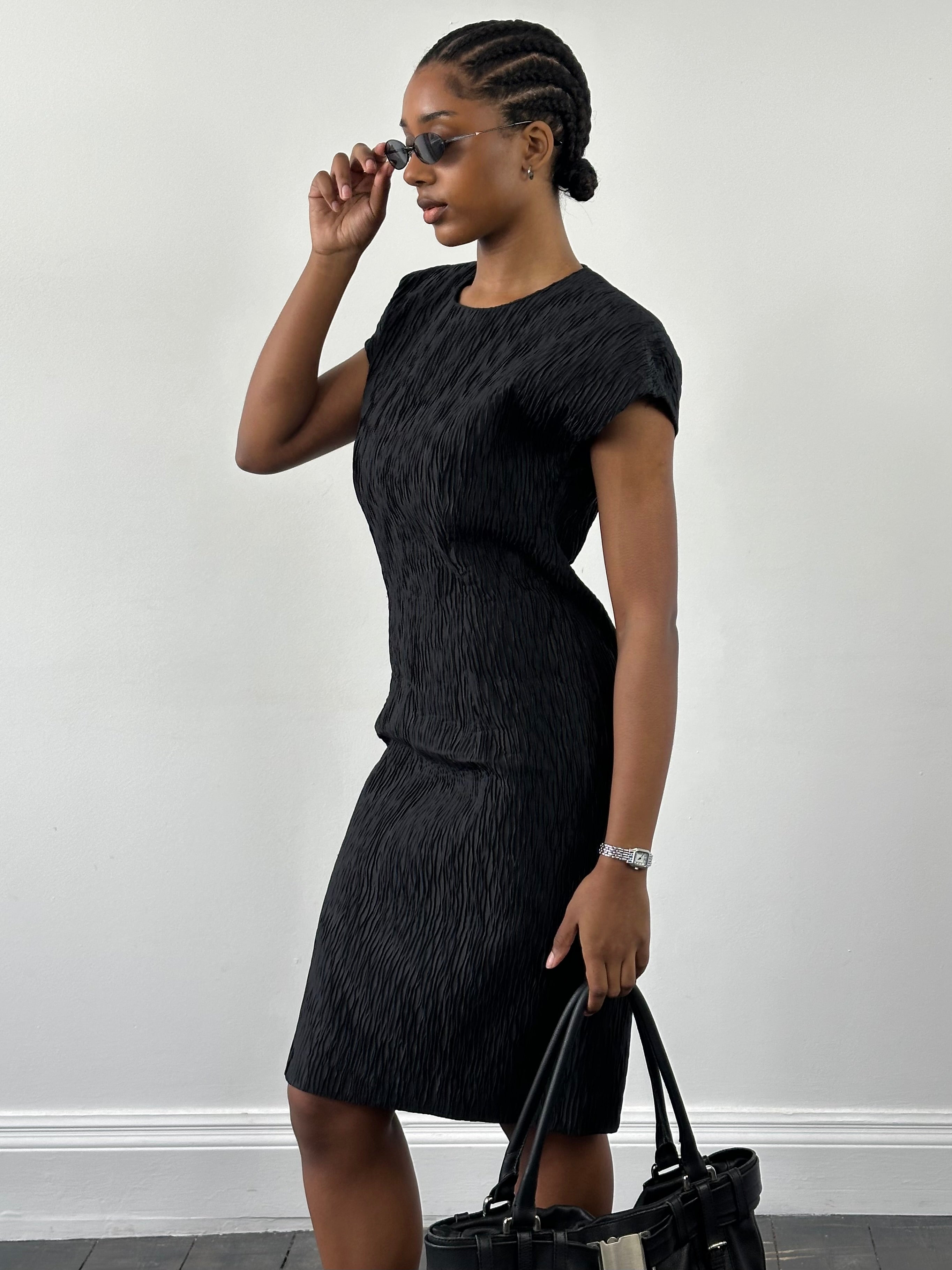 Vintage Italian sleeveless pleated midi dress in S/M size, featuring classic vintage style and elegant design.