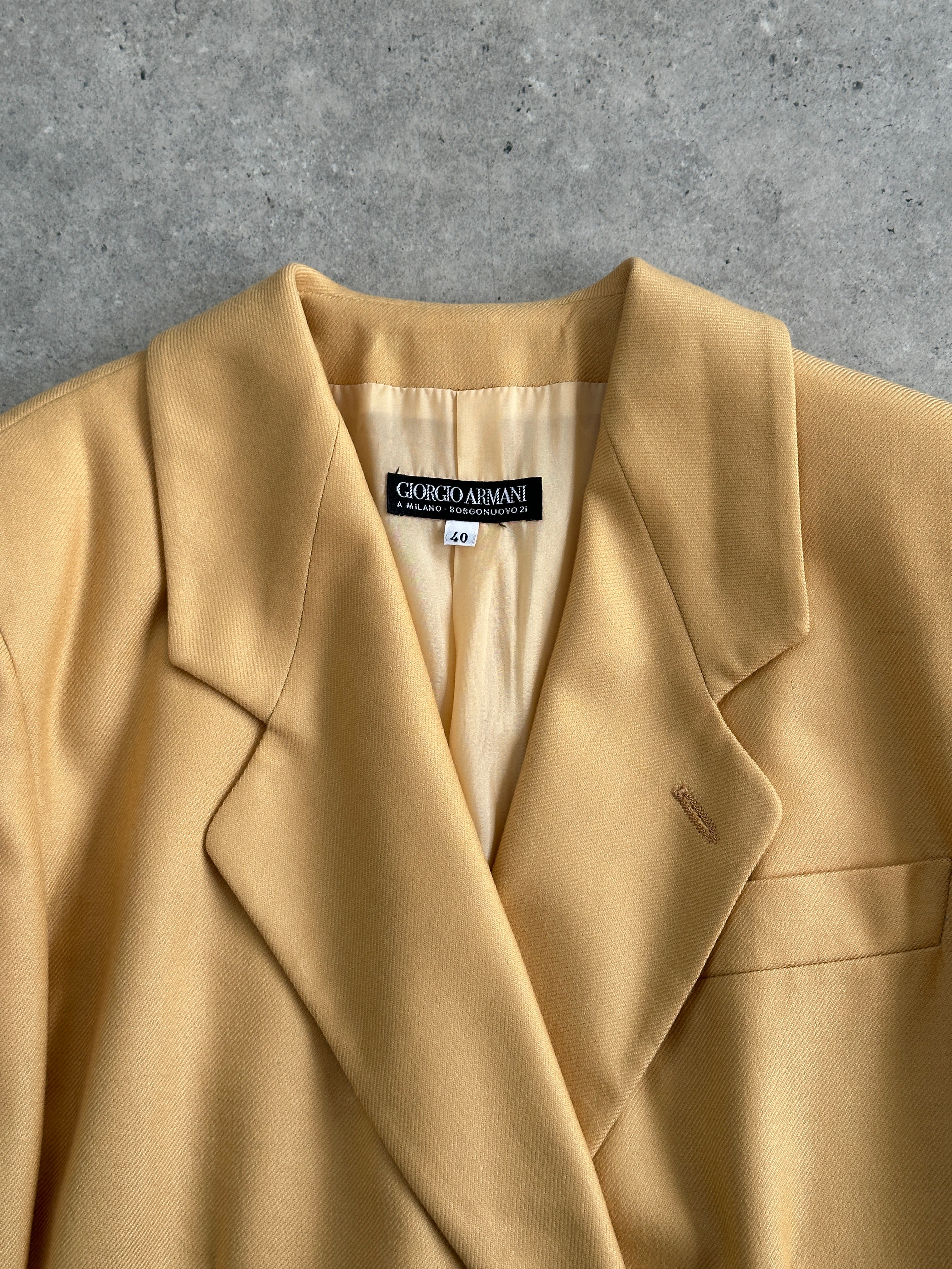 Giorgio Armani Black Label fitted wool blazer in black, size S/M, displayed on a hanger with a tailored silhouette.