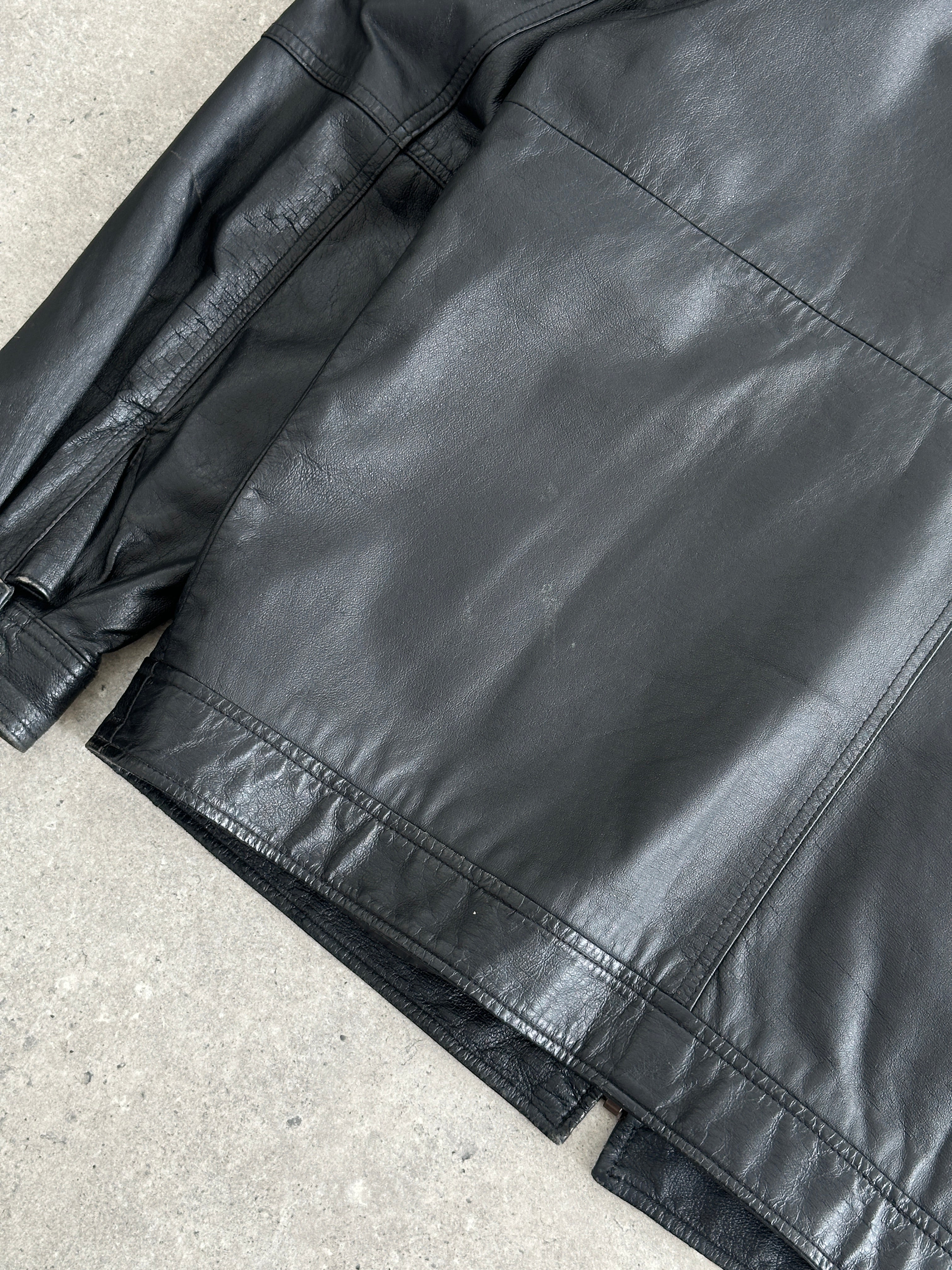 Vintage 1990s minimal leather jacket in size L/XL, classic black leather with sleek design and clean lines.