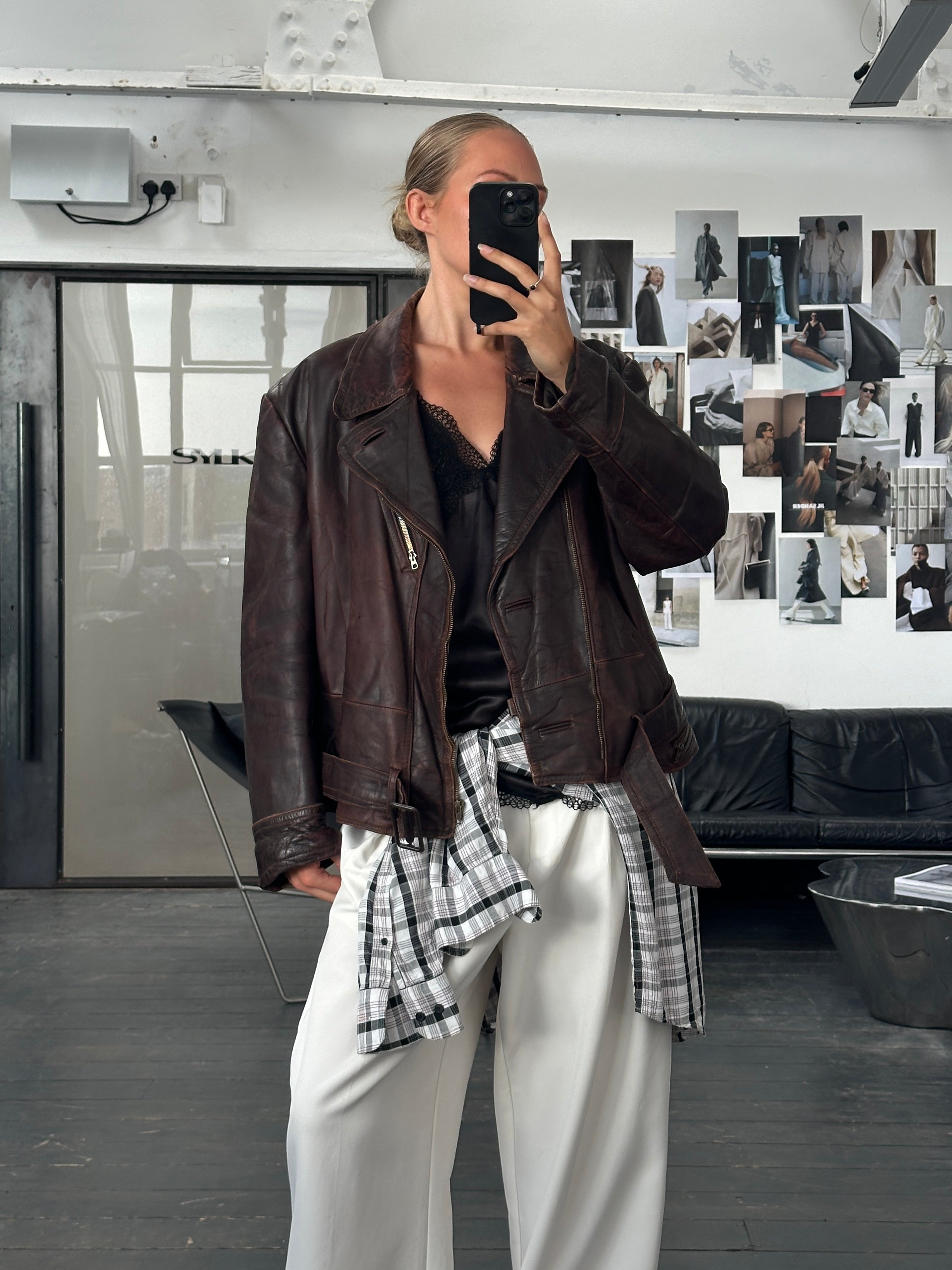 Vintage 1980s distressed leather biker jacket, large/extra-large size, featuring rugged style and classic motorcycle-inspired design.