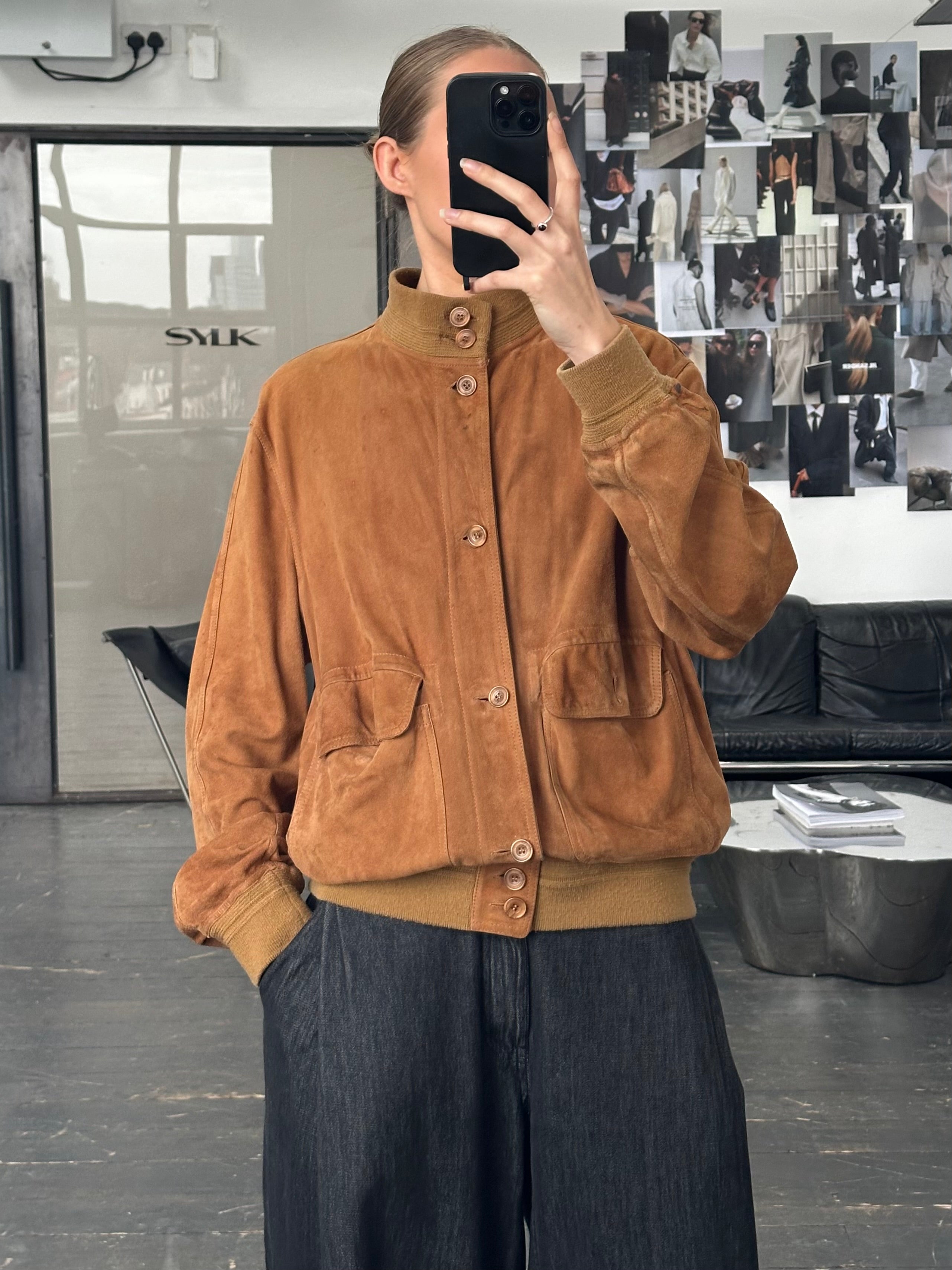 Vintage Italian 1980s reversible suede leather jacket, size large, showing the soft brown and tan sides with classic stitching details.