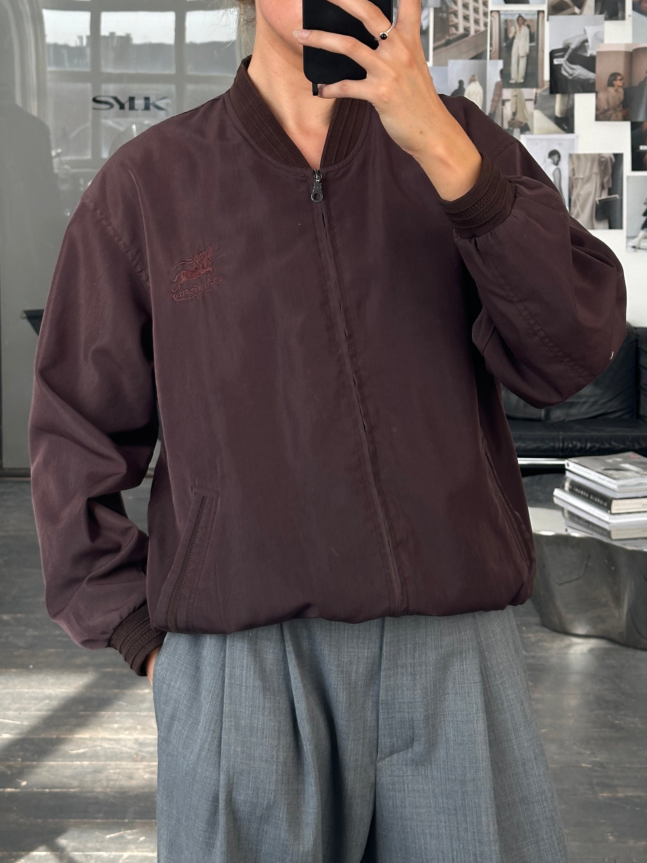 Vintage 2000s bomber jacket in size M/L, featuring classic design with a worn-in leather look and retro style.