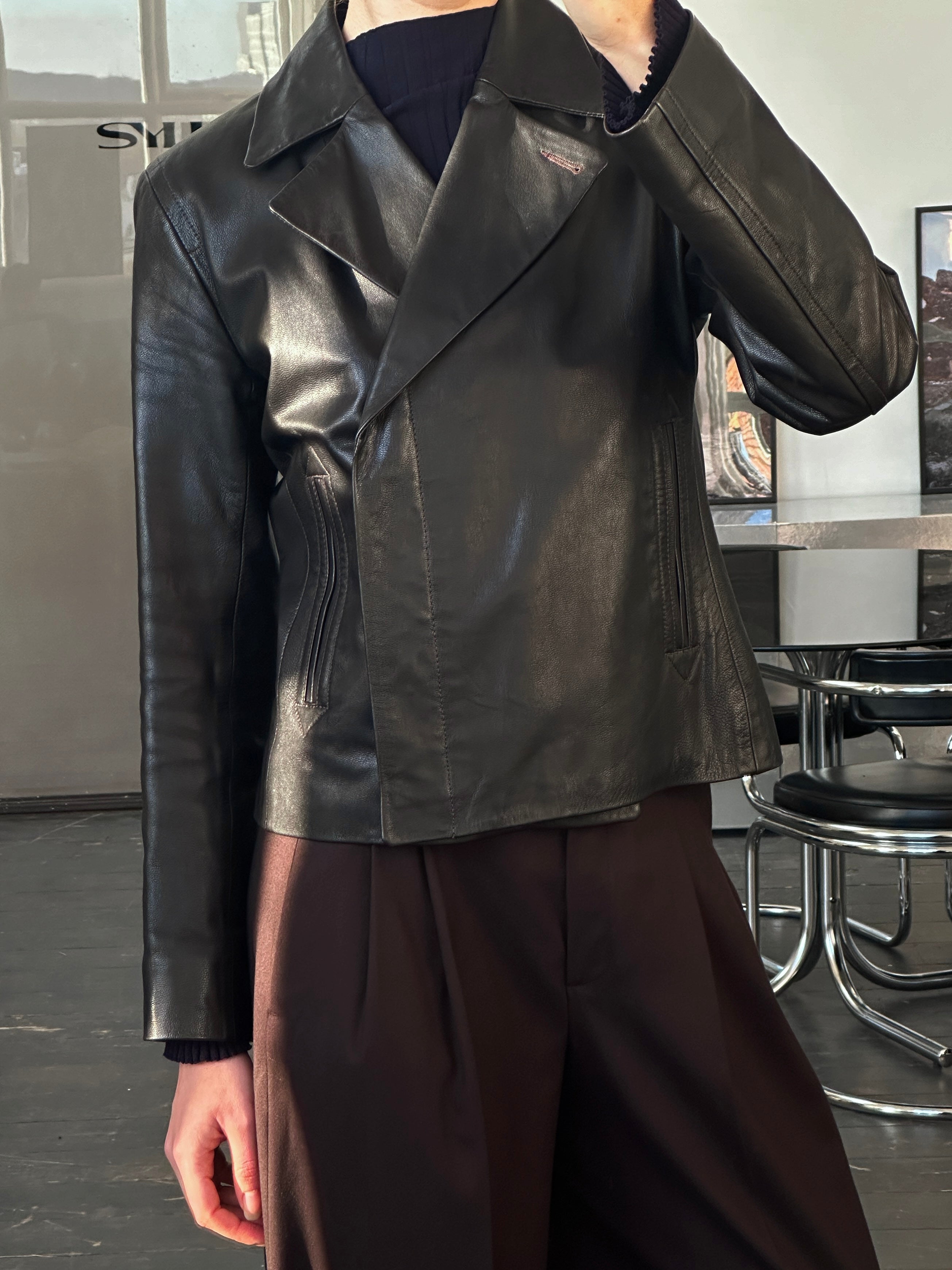 Nicole Farhi 1990s leather jacket in size S, black with classic collar and zip closure, displayed on a hanger.