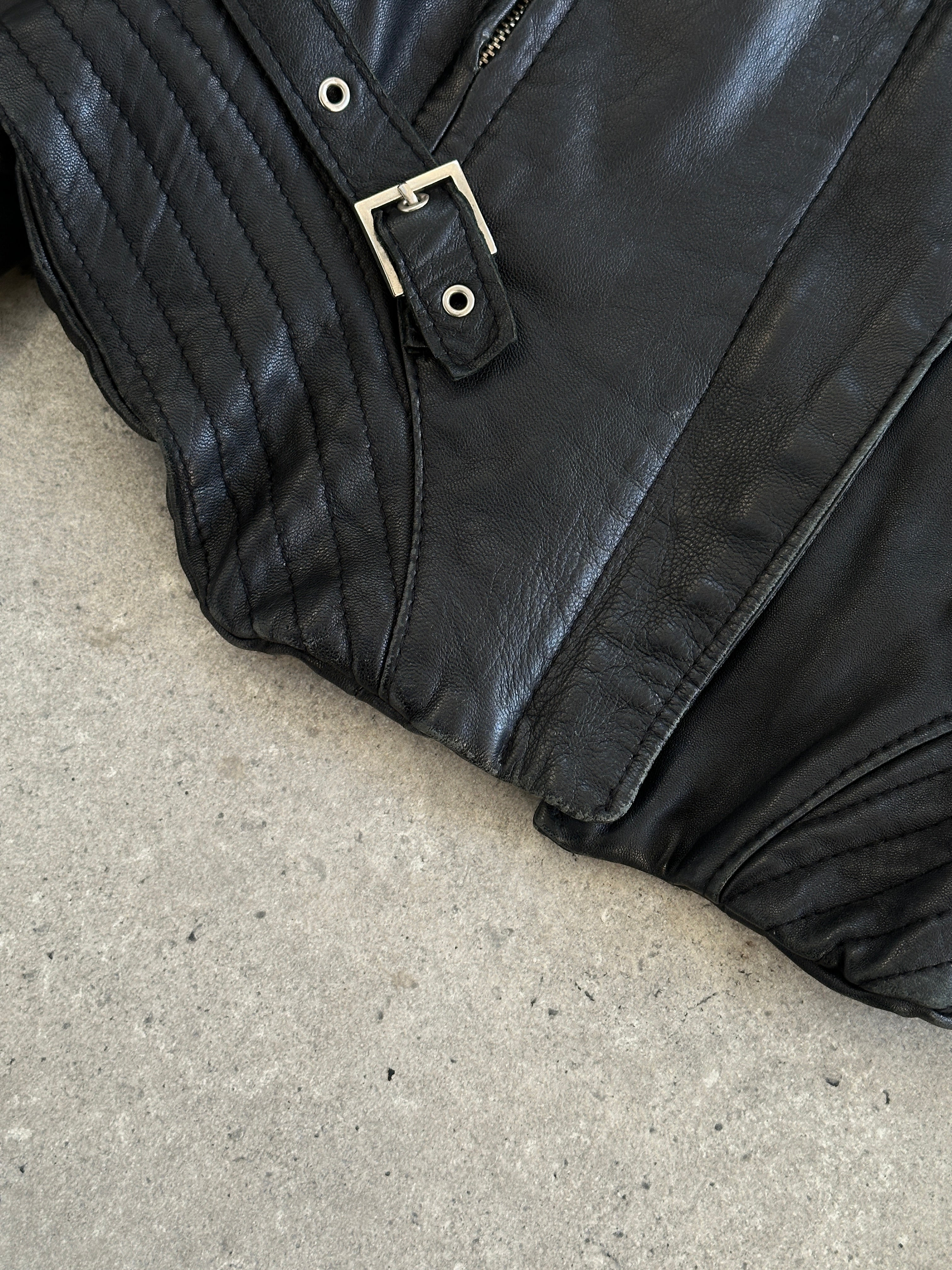 Vintage 1990s fitted leather jacket with buckled details, Italian craftsmanship, size small, stylish vintage leather outerwear.