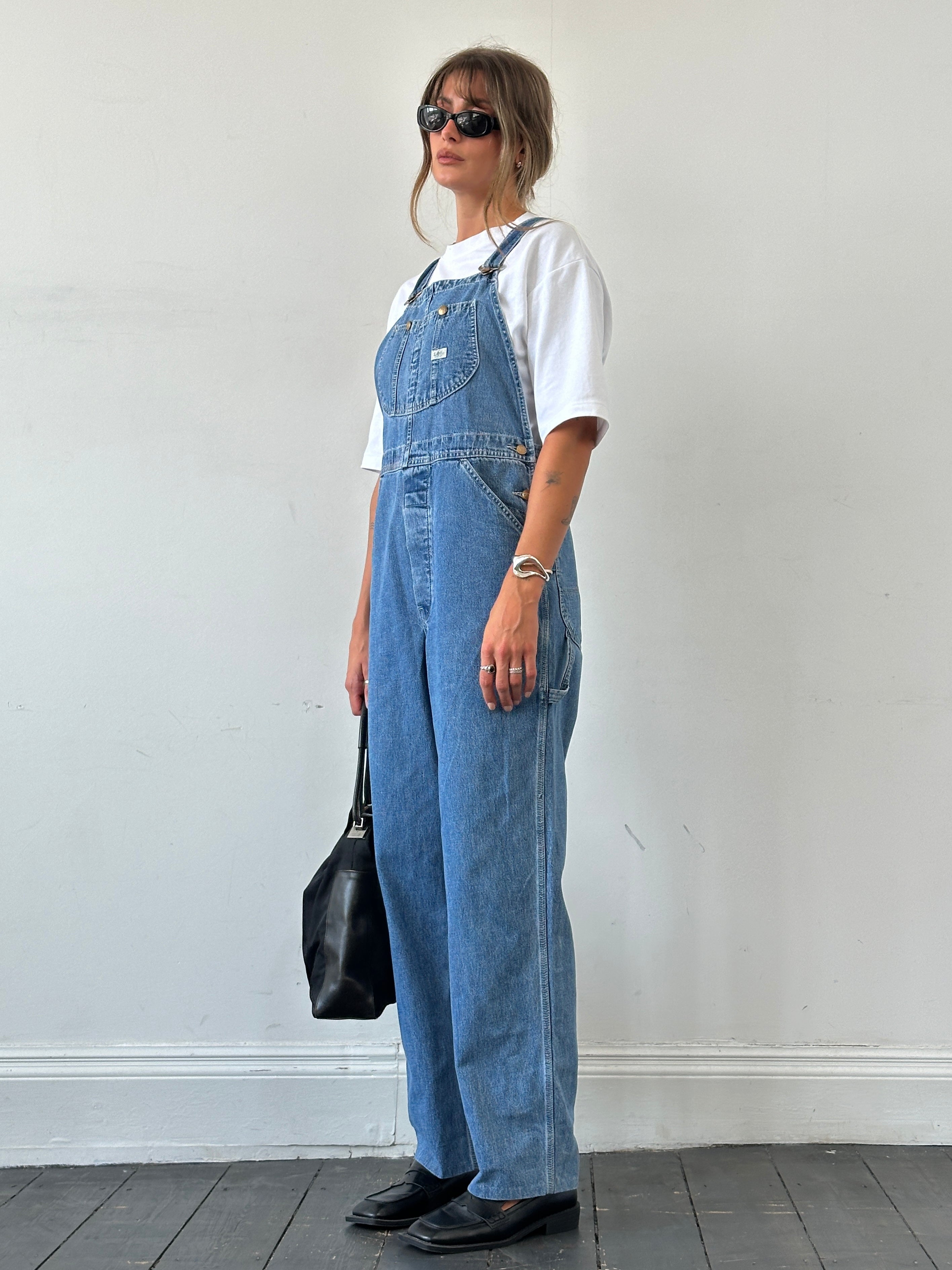 Lee Pure Cotton Denim Dungarees in size M, featuring classic blue denim fabric with adjustable shoulder straps and front pockets.