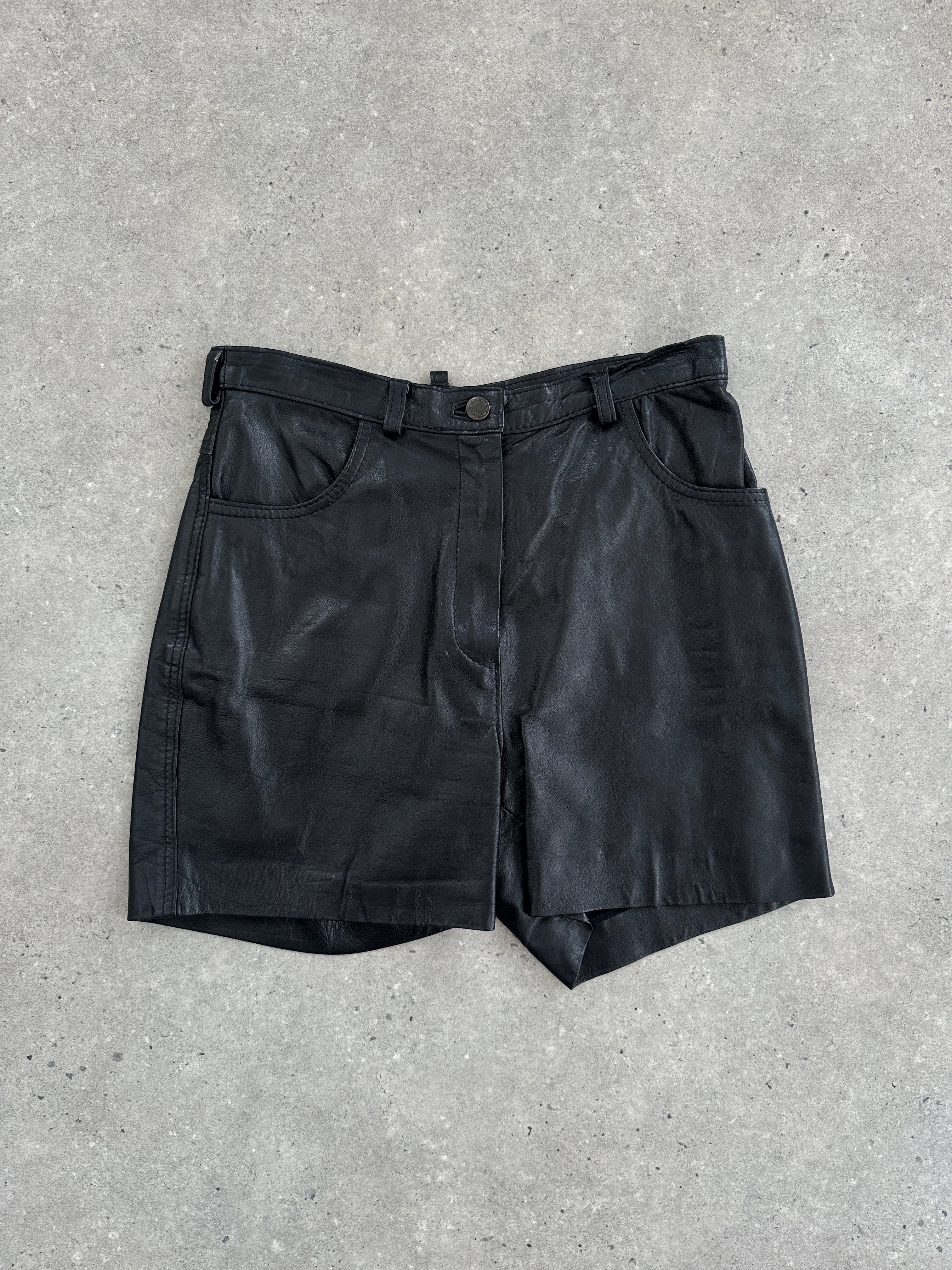 Vintage leather high-waisted mini shorts, size W27, with a stylish vintage design and tailored fit, shown on a model.