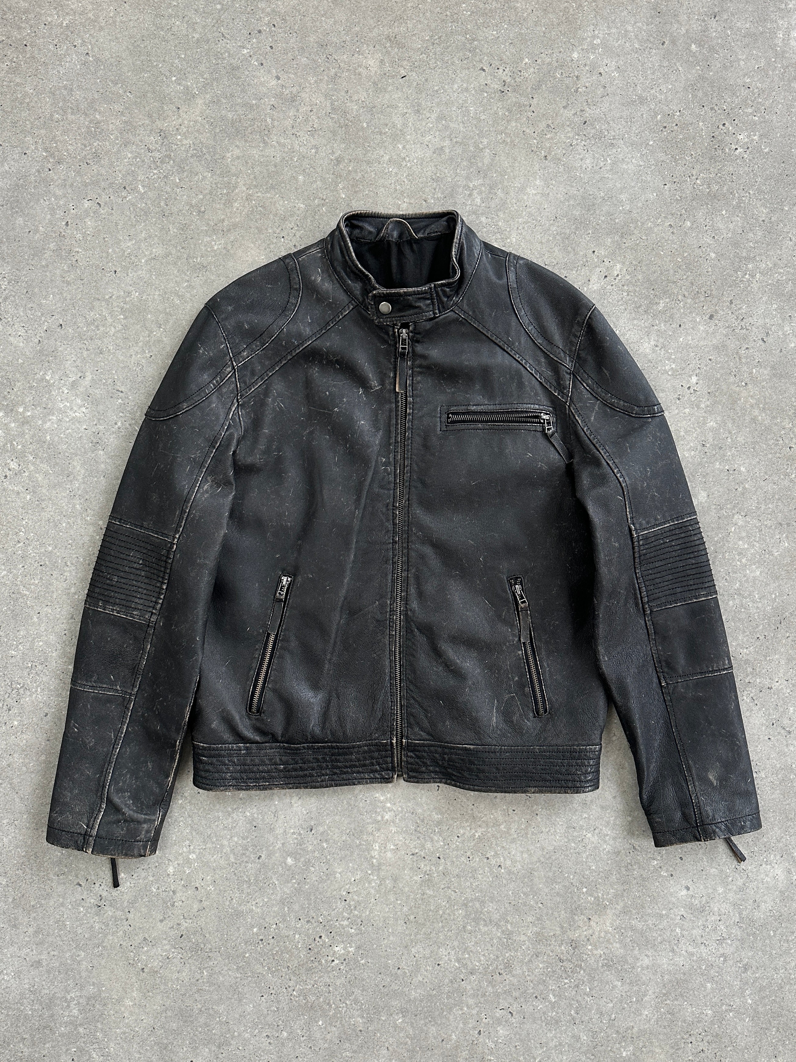 Vintage distressed leather moto jacket in size M/L, featuring rugged texture and classic motorcycle style.