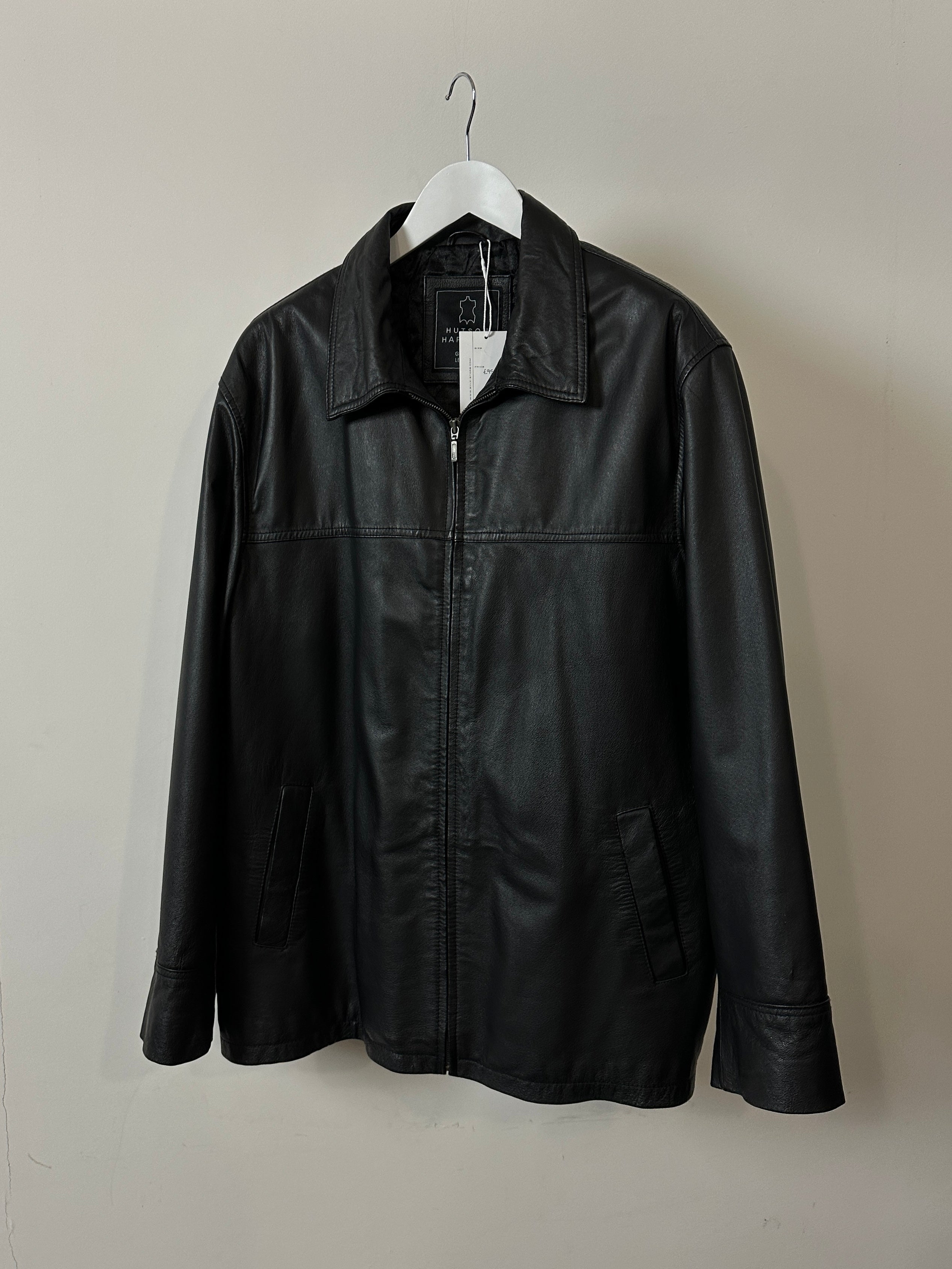 Vintage brand vintage minimal leather jacket in size XL, showing smooth leather texture and classic design on a hanger.