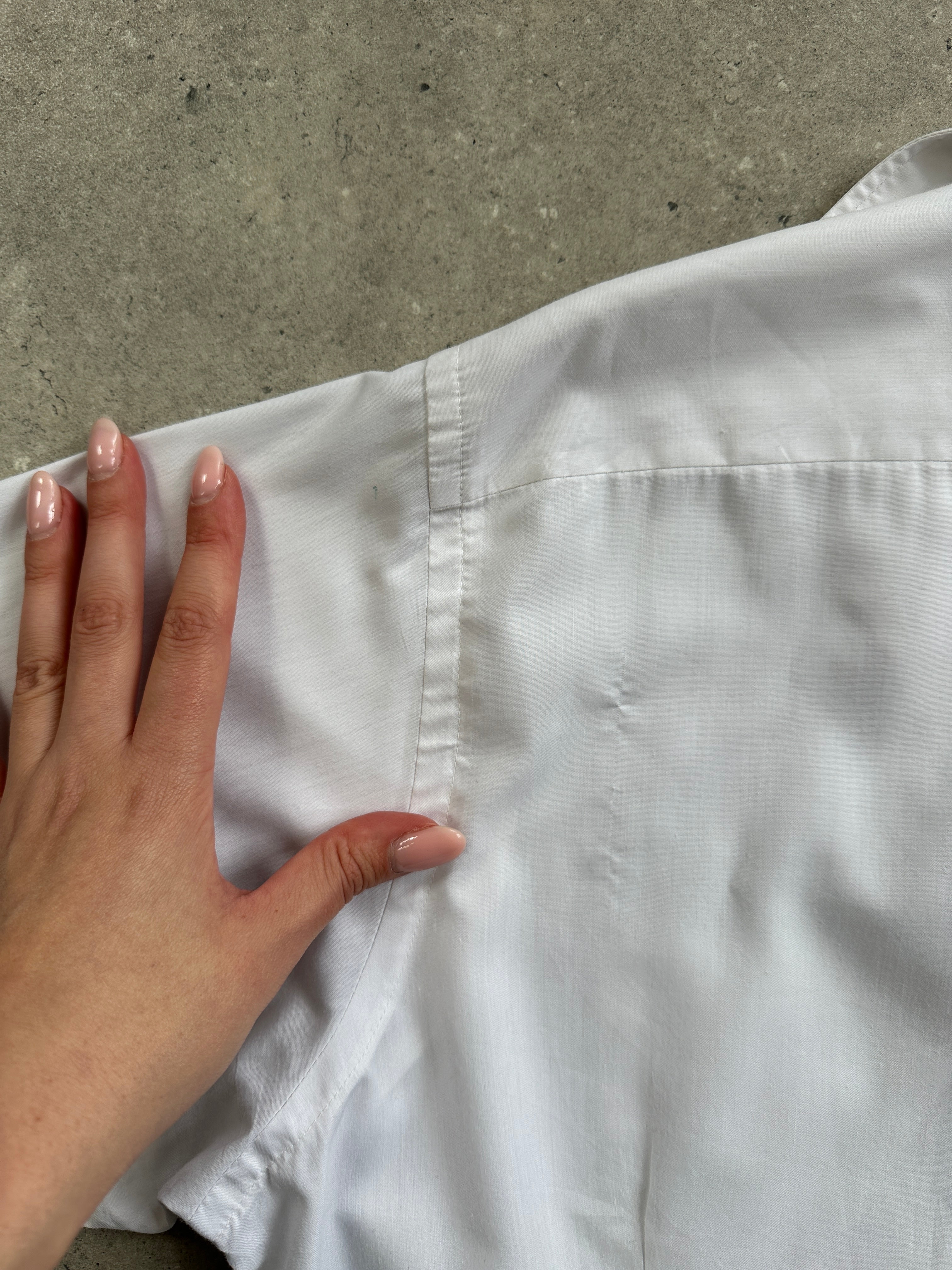 Christian Dior cotton logo shirt in size L, featuring a classic white design with the Dior branding on the chest.