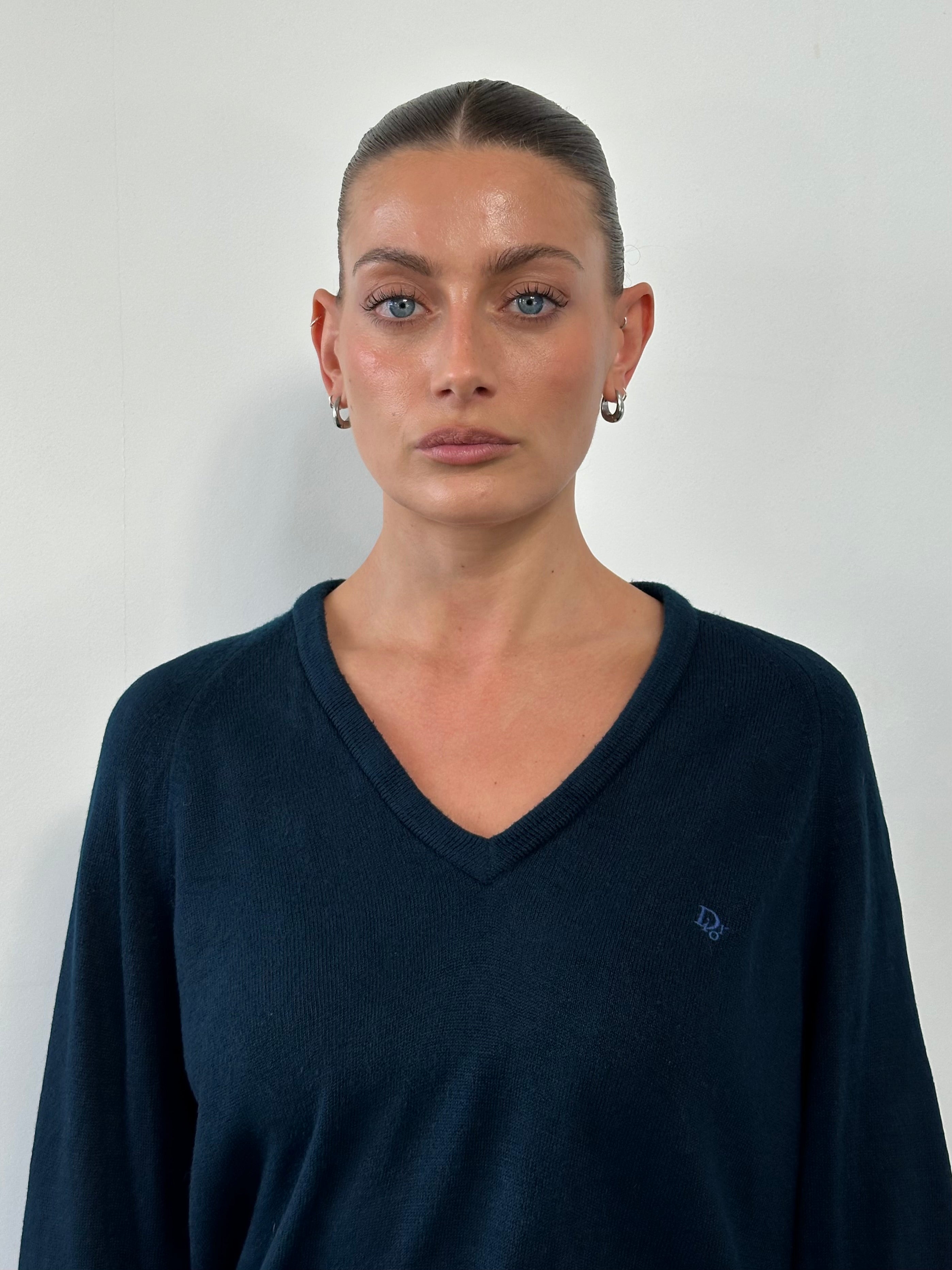 Christian Dior 1980s V-neck knitted jumper in size L, featuring the Dior logo and classic design, displayed on a neutral background.