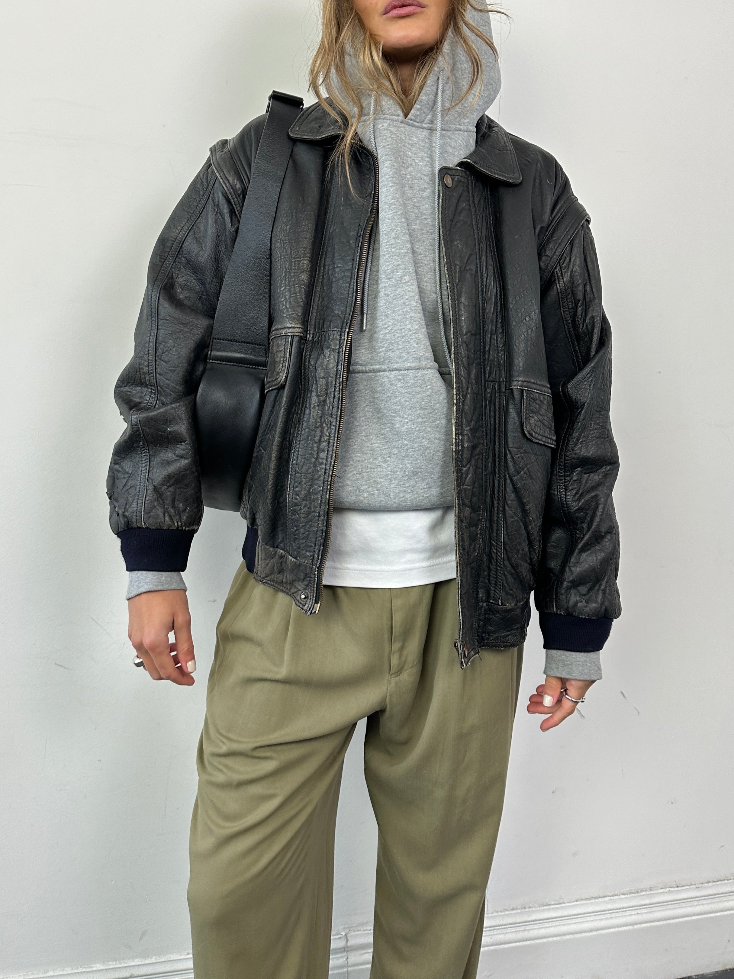 Vintage distressed leather bomber gilet jacket in M/L size, featuring rugged leather and classic design.