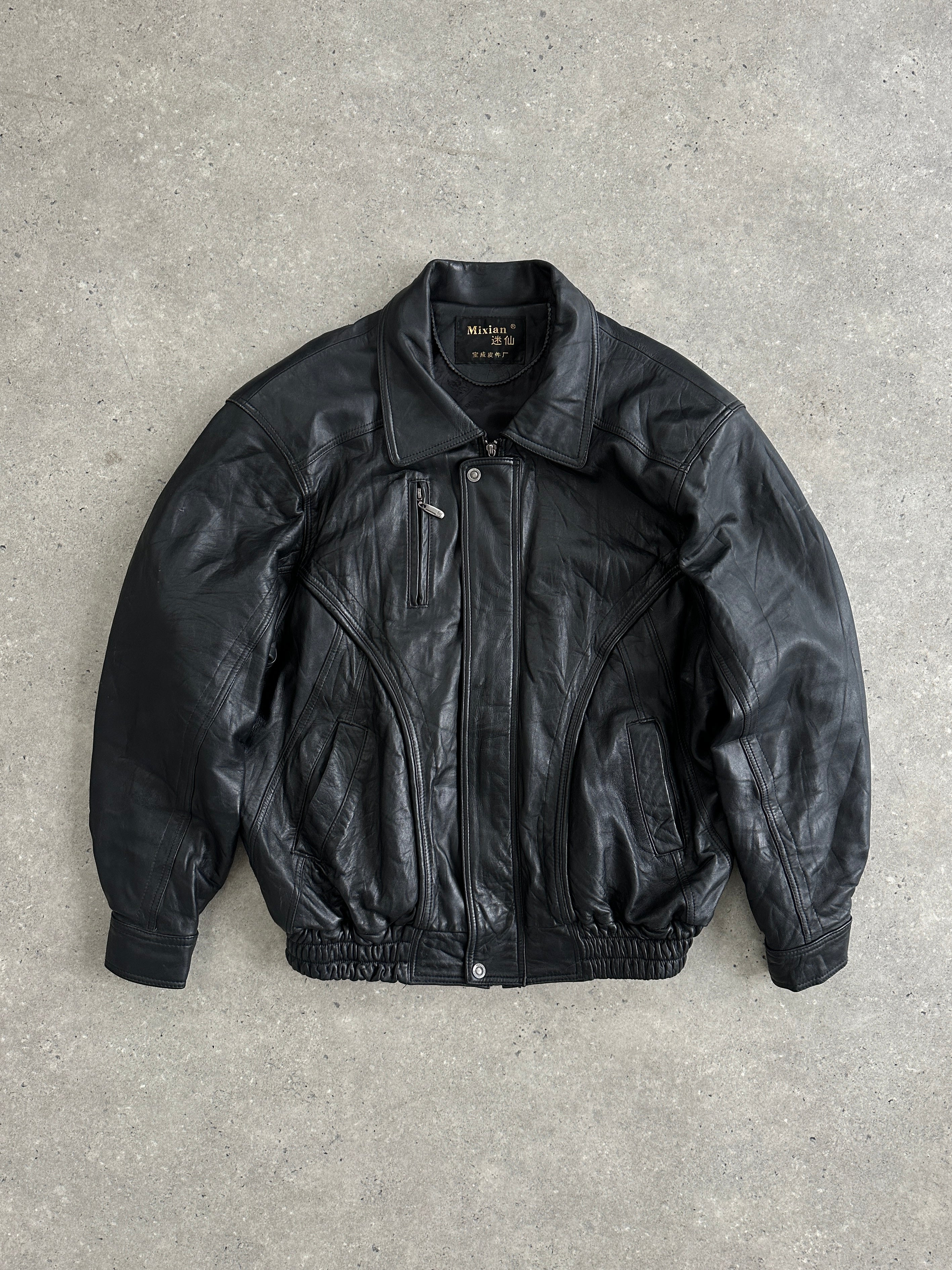 Vintage leather bomber jacket in XL size, featuring classic design with ribbed cuffs and collar, shown on a hanger.