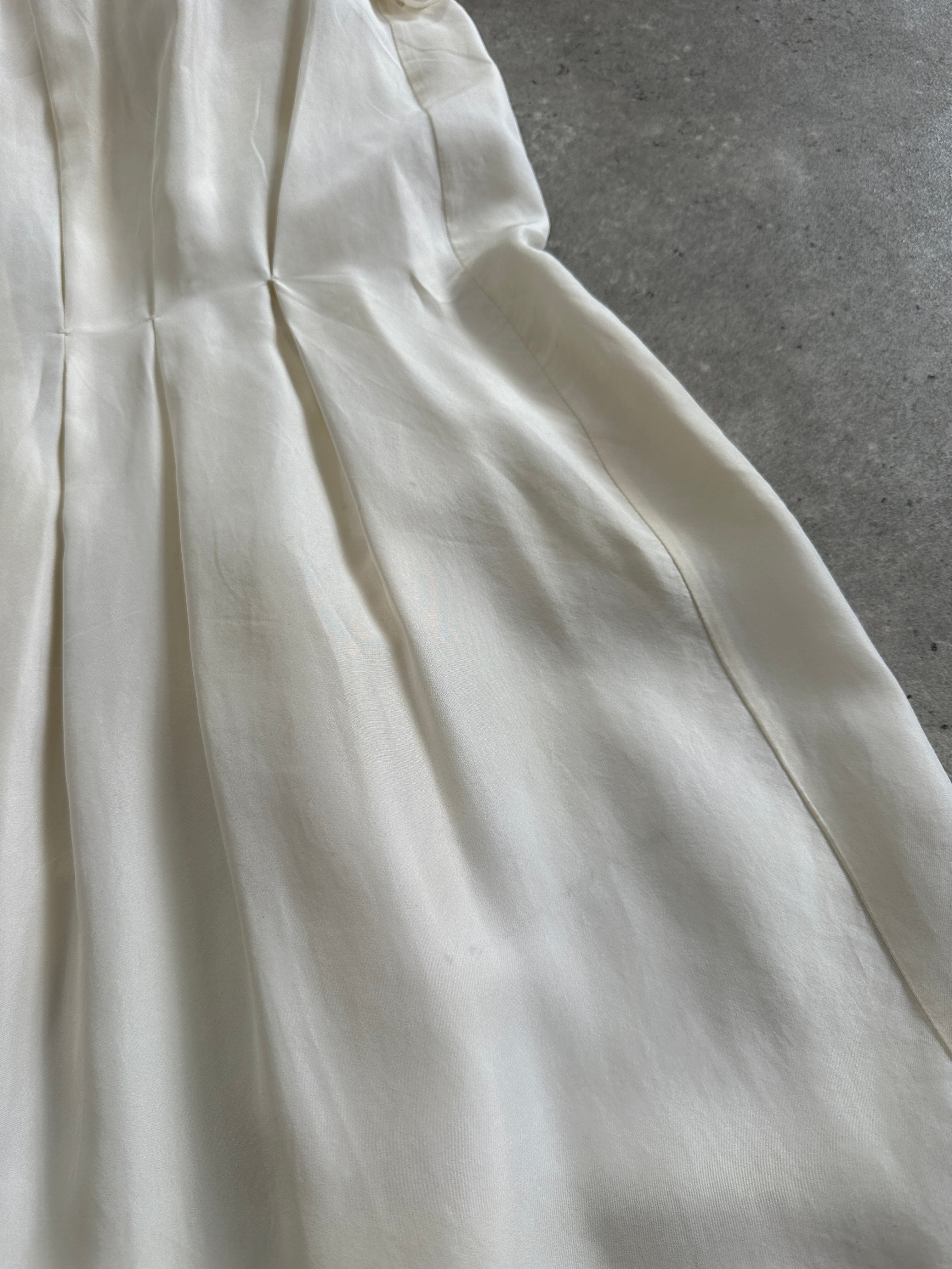 Prada 2012 pure silk pleated slip dress in size large, featuring elegant fabric and classic design, shown on a hanger.