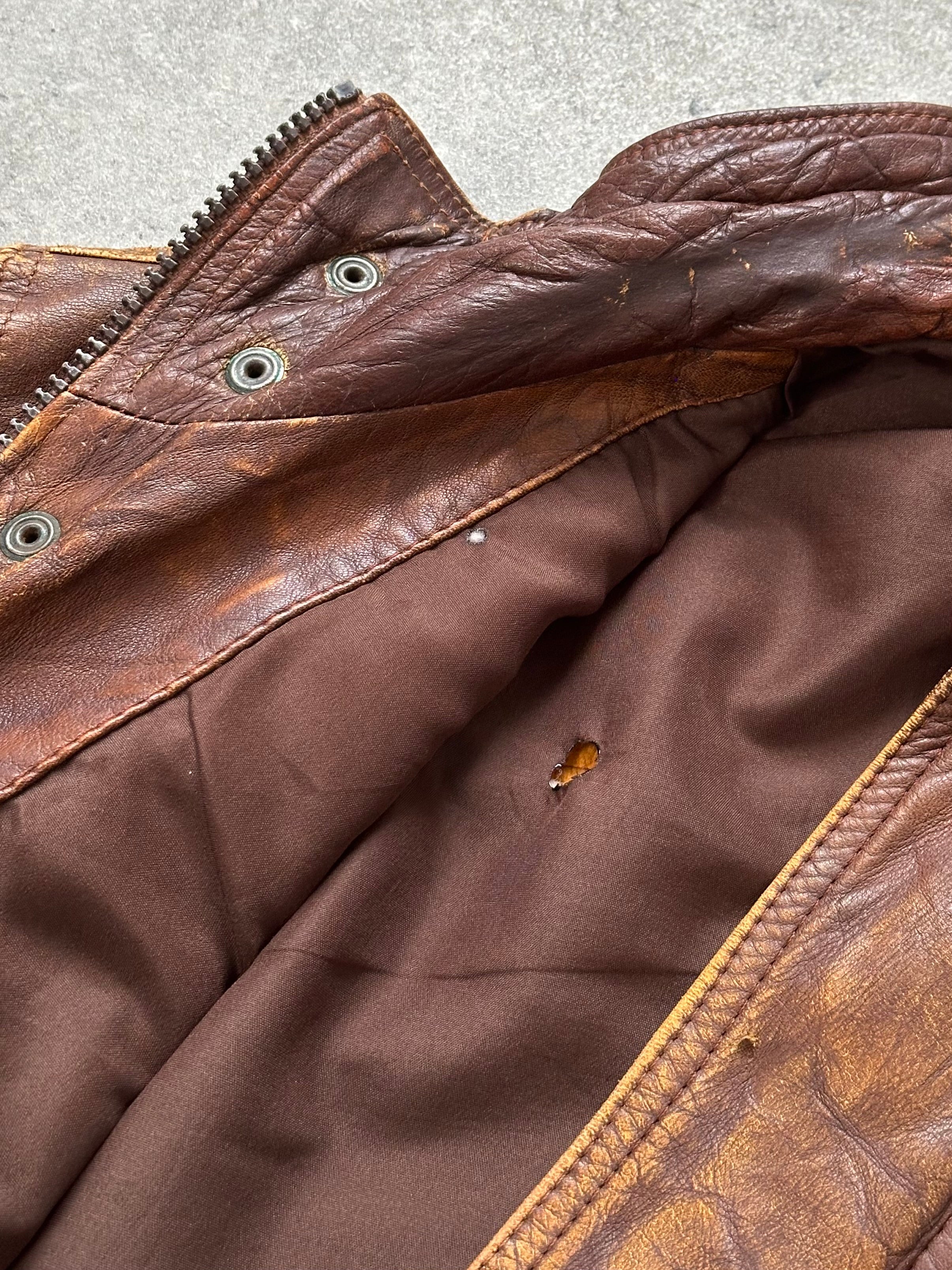 Vintage 1990s aged leather bomber jacket in XL size, featuring a classic design with distressed leather and vintage style.