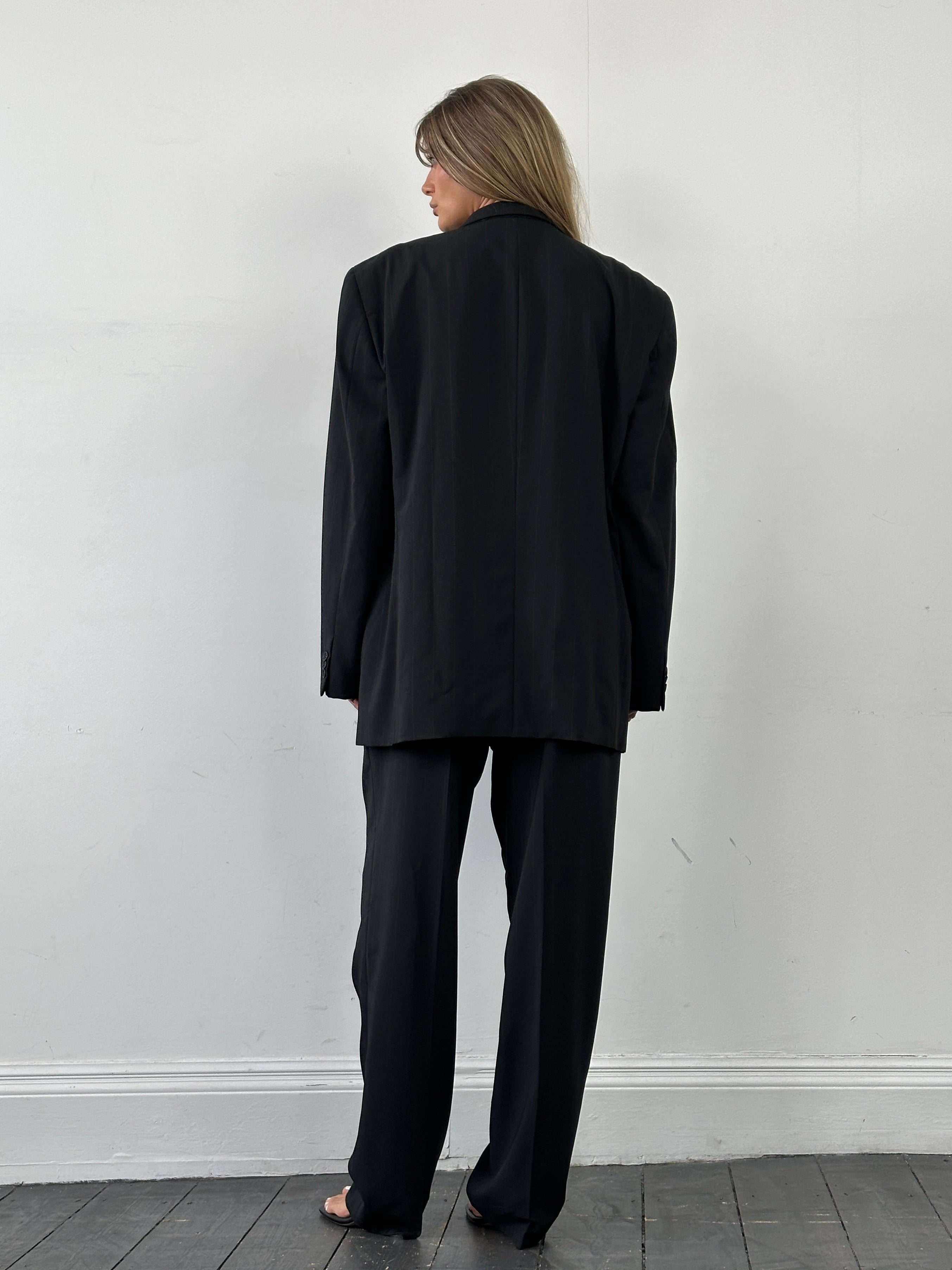 Giorgio Armani Le Collezioni pinstripe wool single-breasted suit in size 46R/W36, displayed on a hanger with a classic tailored fit.