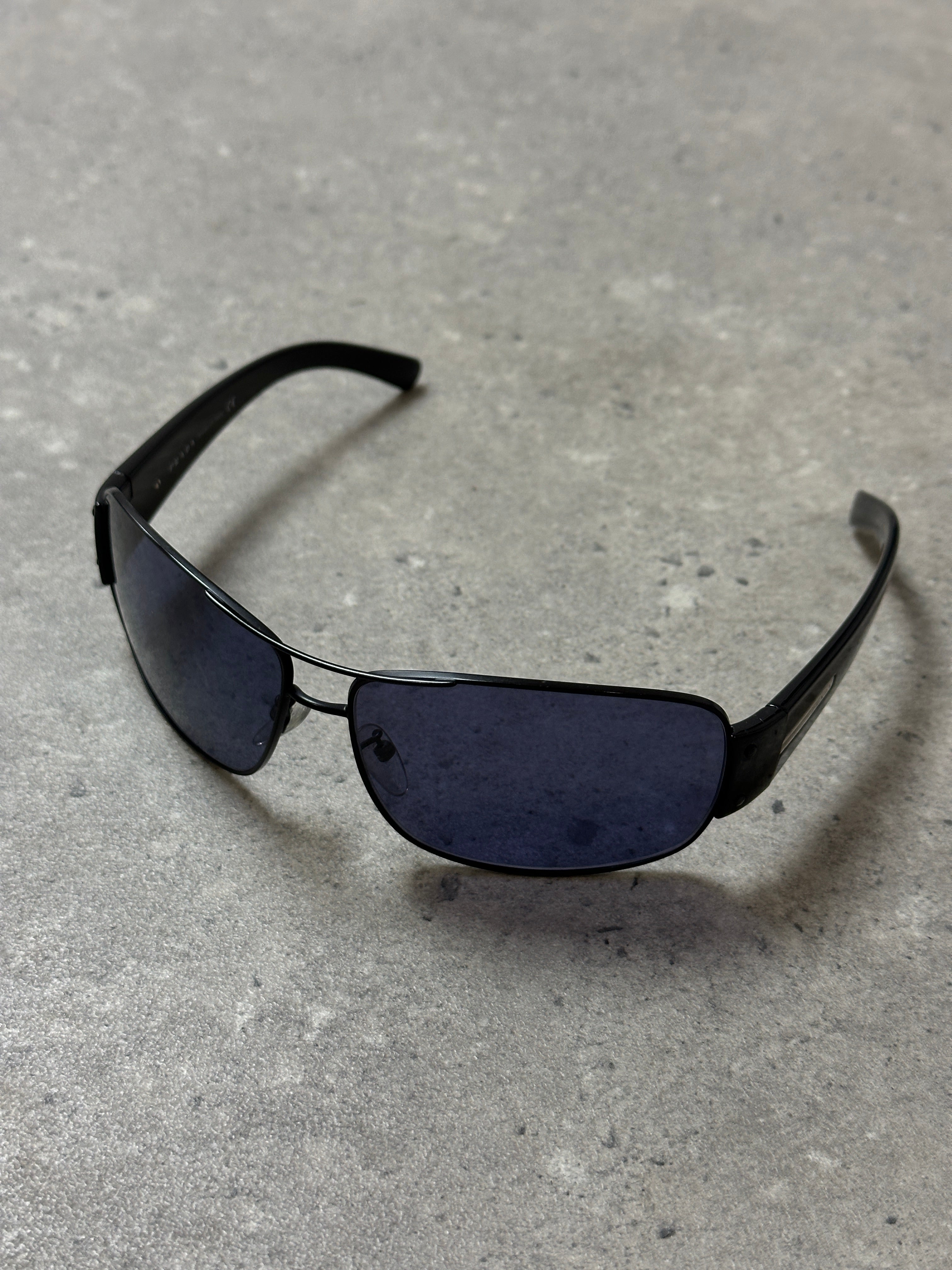 Prada aviator shield sunglasses with large tinted lenses and metal frame, stylish and protective eyewear for sun protection.