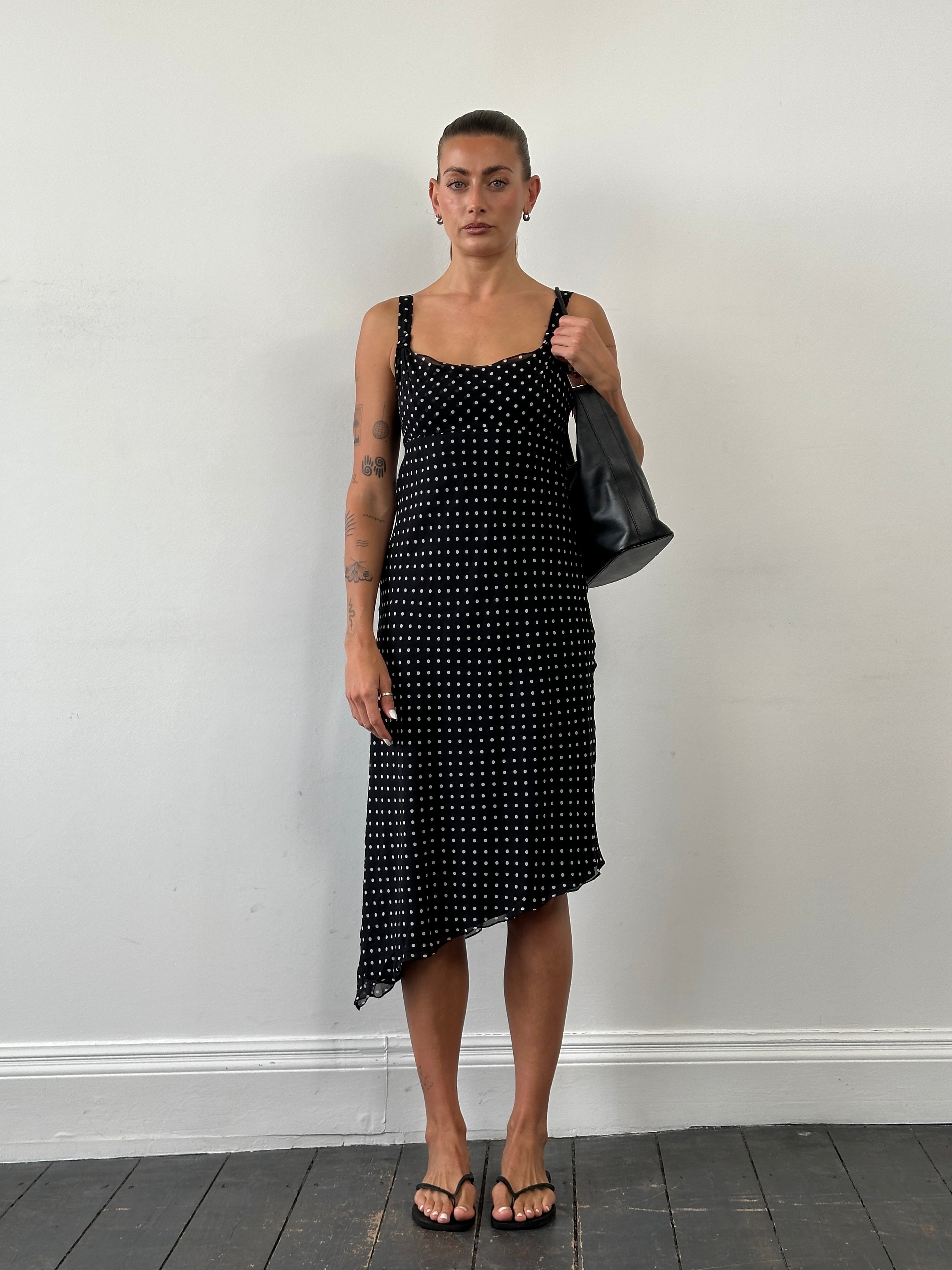 Max Mara Pianoforte 1990s pure silk polkadot asymmetric midi dress in black and white, front view with flowing fabric.