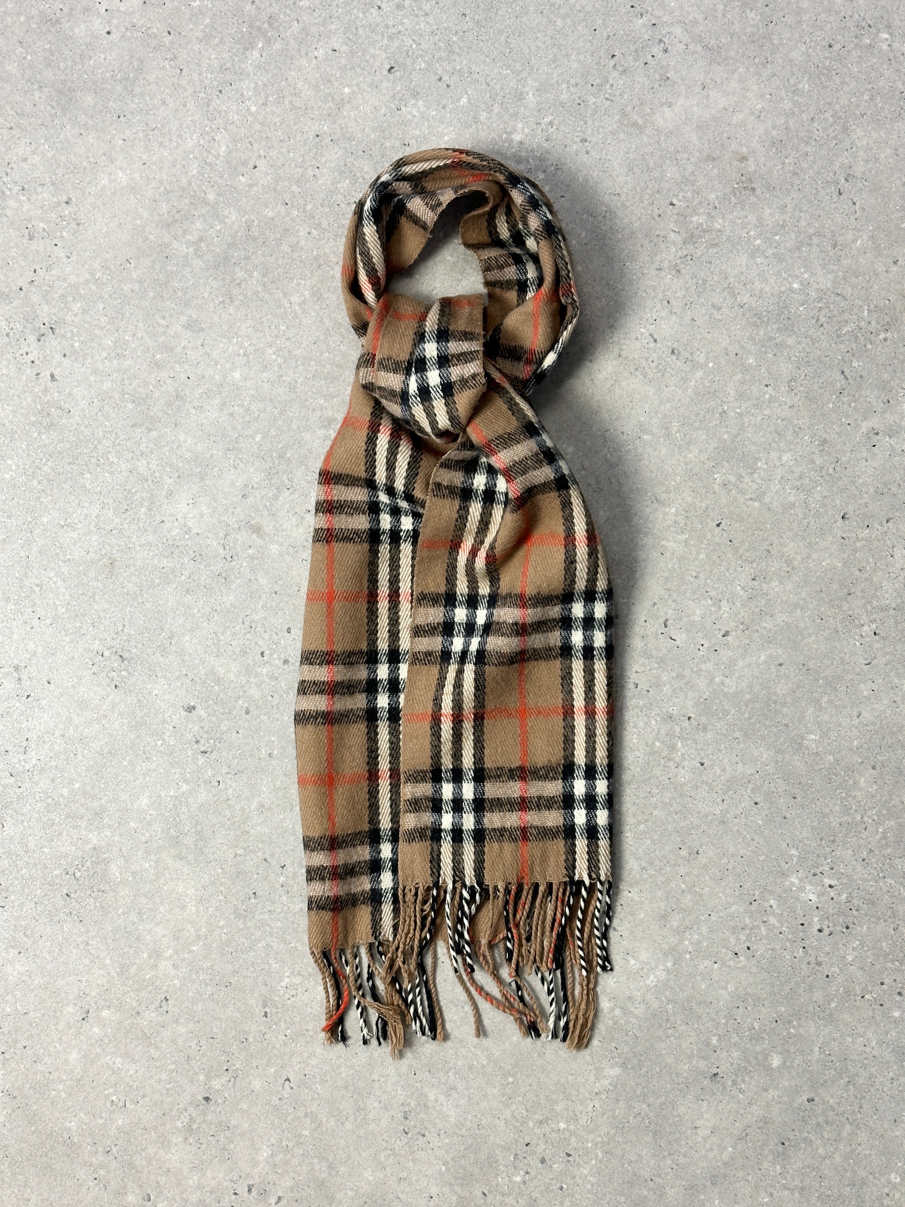 Vintage Nova Check Scarf featuring classic plaid pattern in warm tones, draped to showcase soft fabric and stylish design.