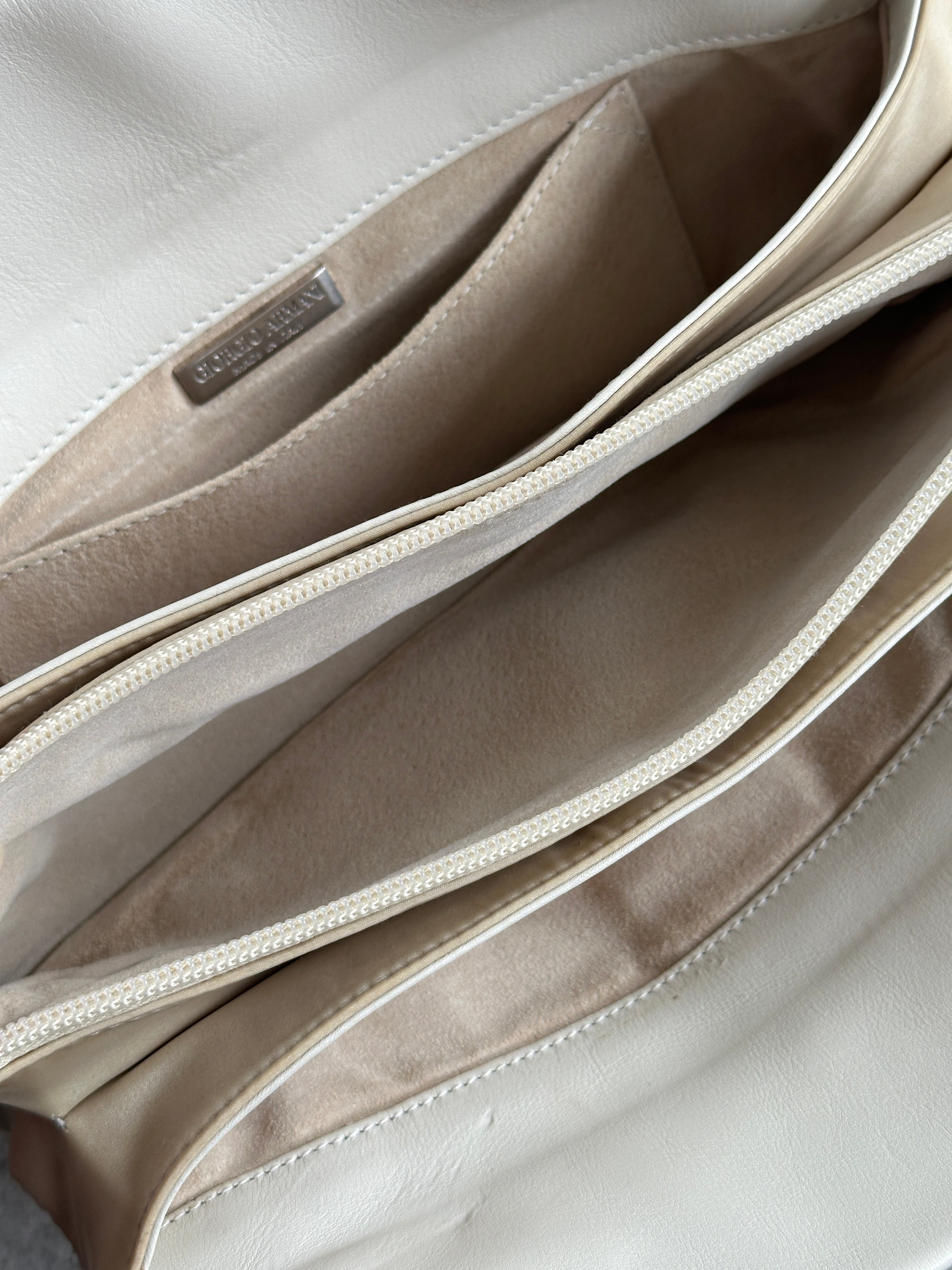 Giorgio Armani Le Collezioni embossed logo handbag with textured leather and sleek design, stylish accessory for women.