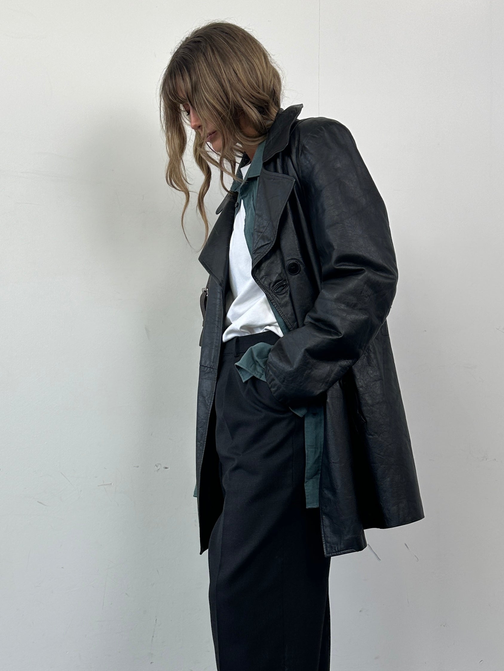 Vintage Italian vintage double-breasted leather jacket, mid-length style in black, with classic design and silver button details.
