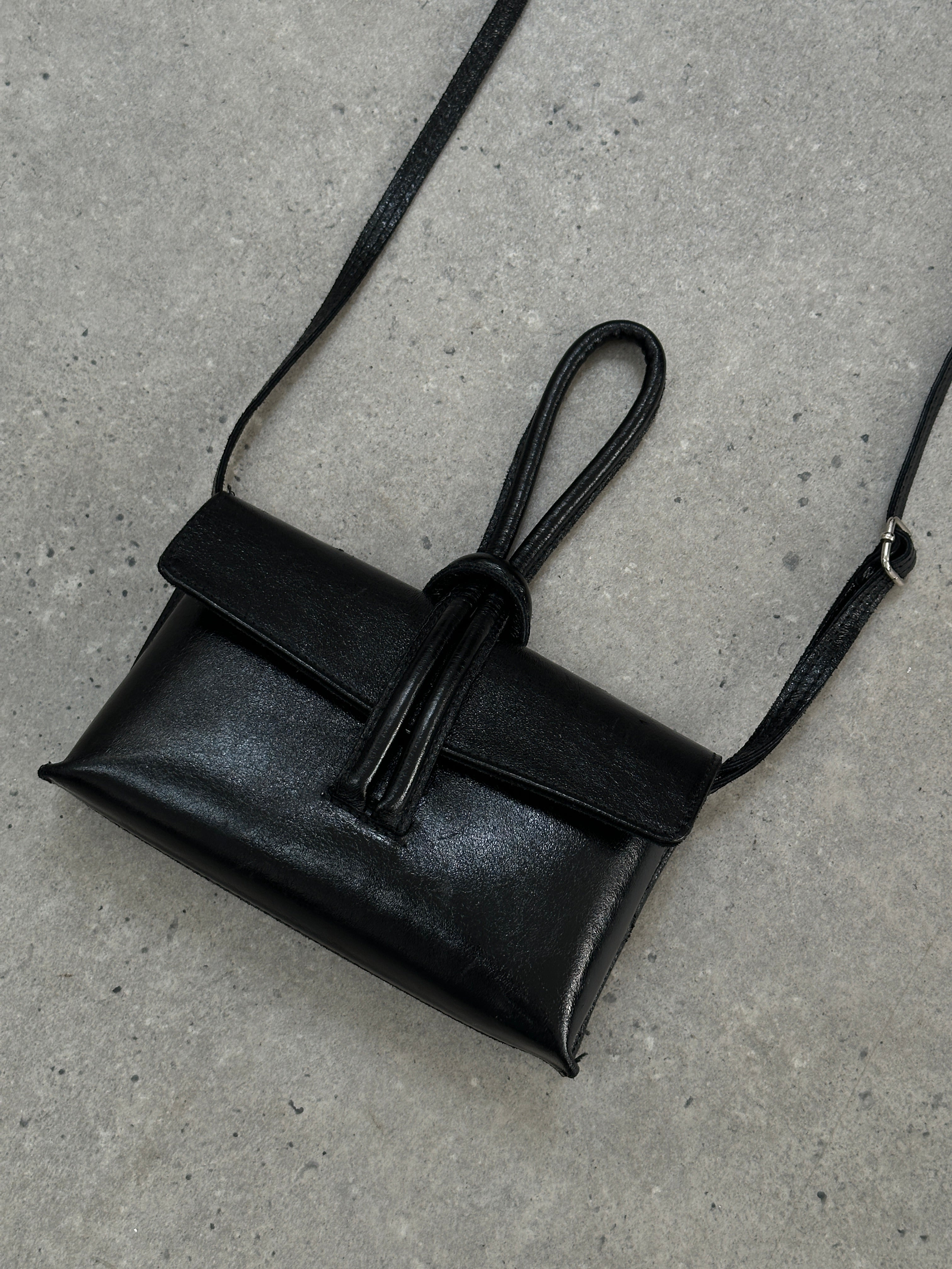 Vintage Italian leather crossbody clutch bag with rustic finish and adjustable strap, perfect for stylish everyday use.