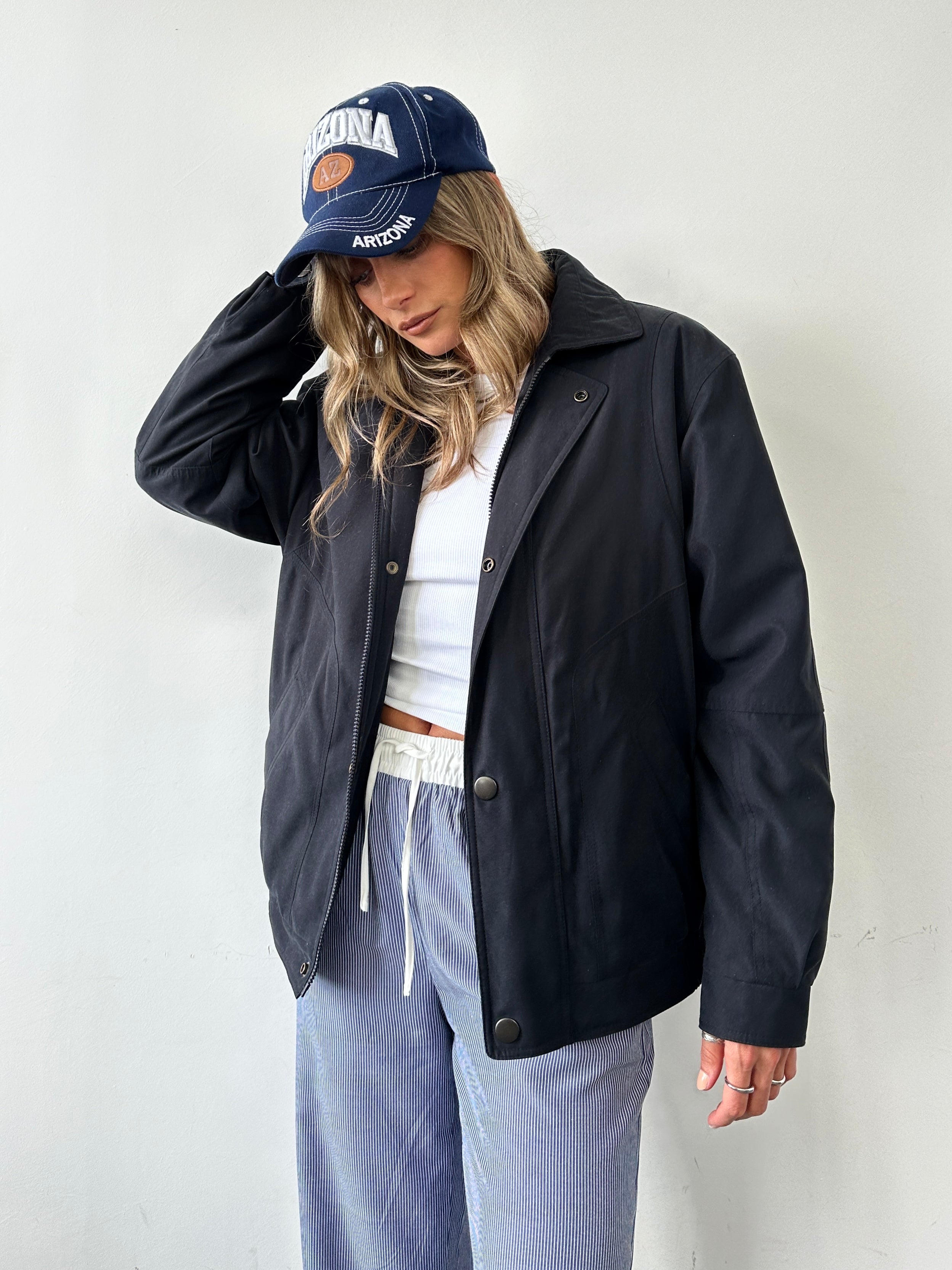 Vintage padded bomber jacket in size large, featuring a classic retro design with quilted padding and ribbed cuffs.