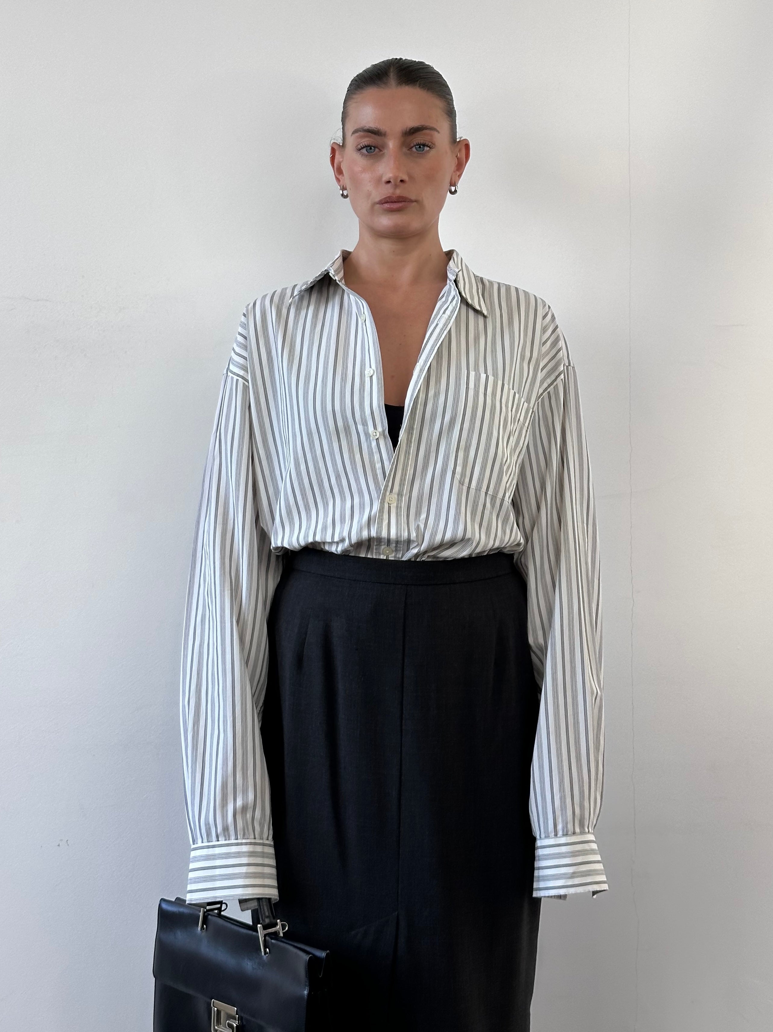 Christian Dior striped pure cotton shirt in XL displayed on a hanger, showcasing its classic design and high-quality fabric.
