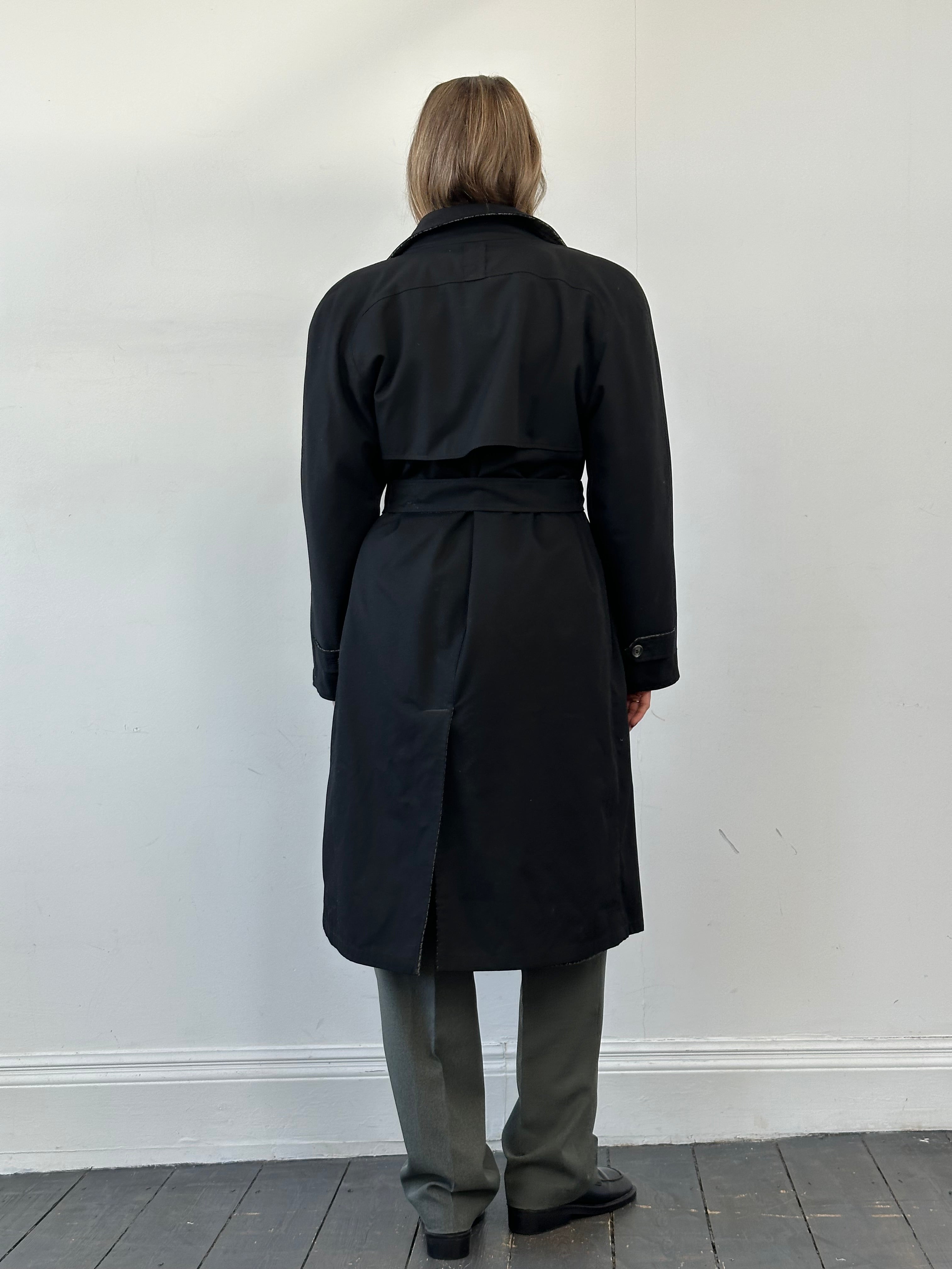 Vintage reversible wool trench coat with belt in size XL, featuring classic design and neutral tones, displayed hanging on a wooden hanger.