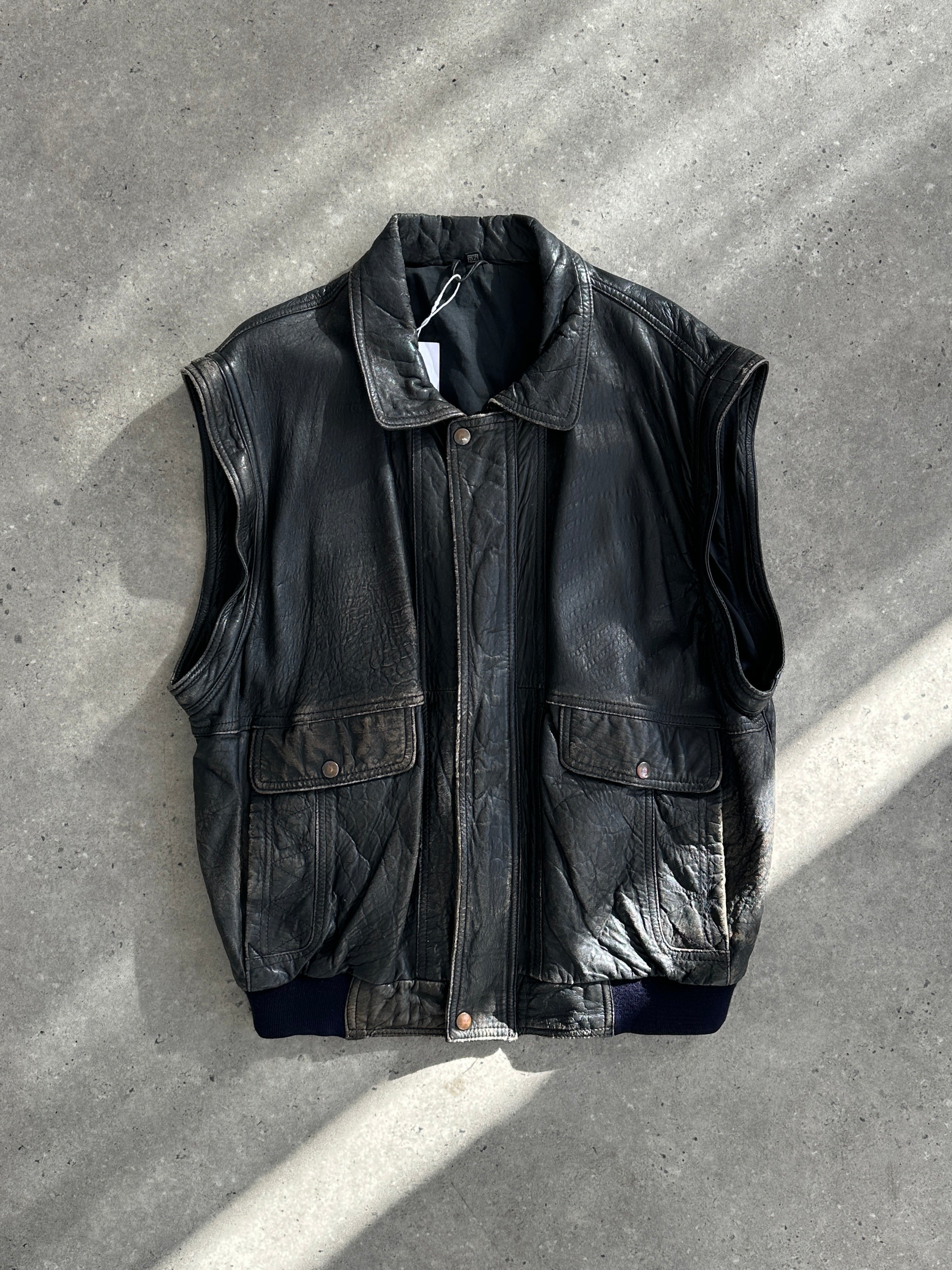 Vintage distressed leather bomber gilet jacket in M/L size, featuring rugged styling and classic leather texture.