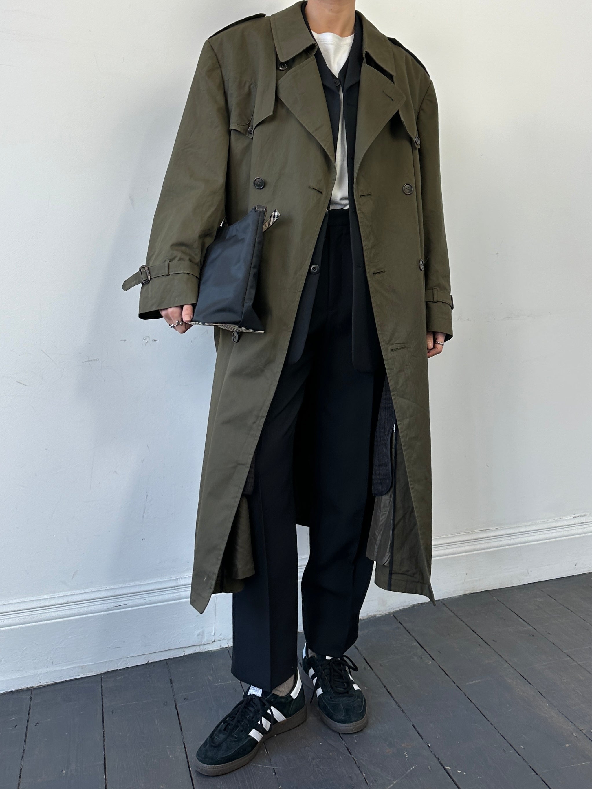 Christian Dior cotton double-breasted trench coat in XL, displayed on a hanger with classic design and neutral color.