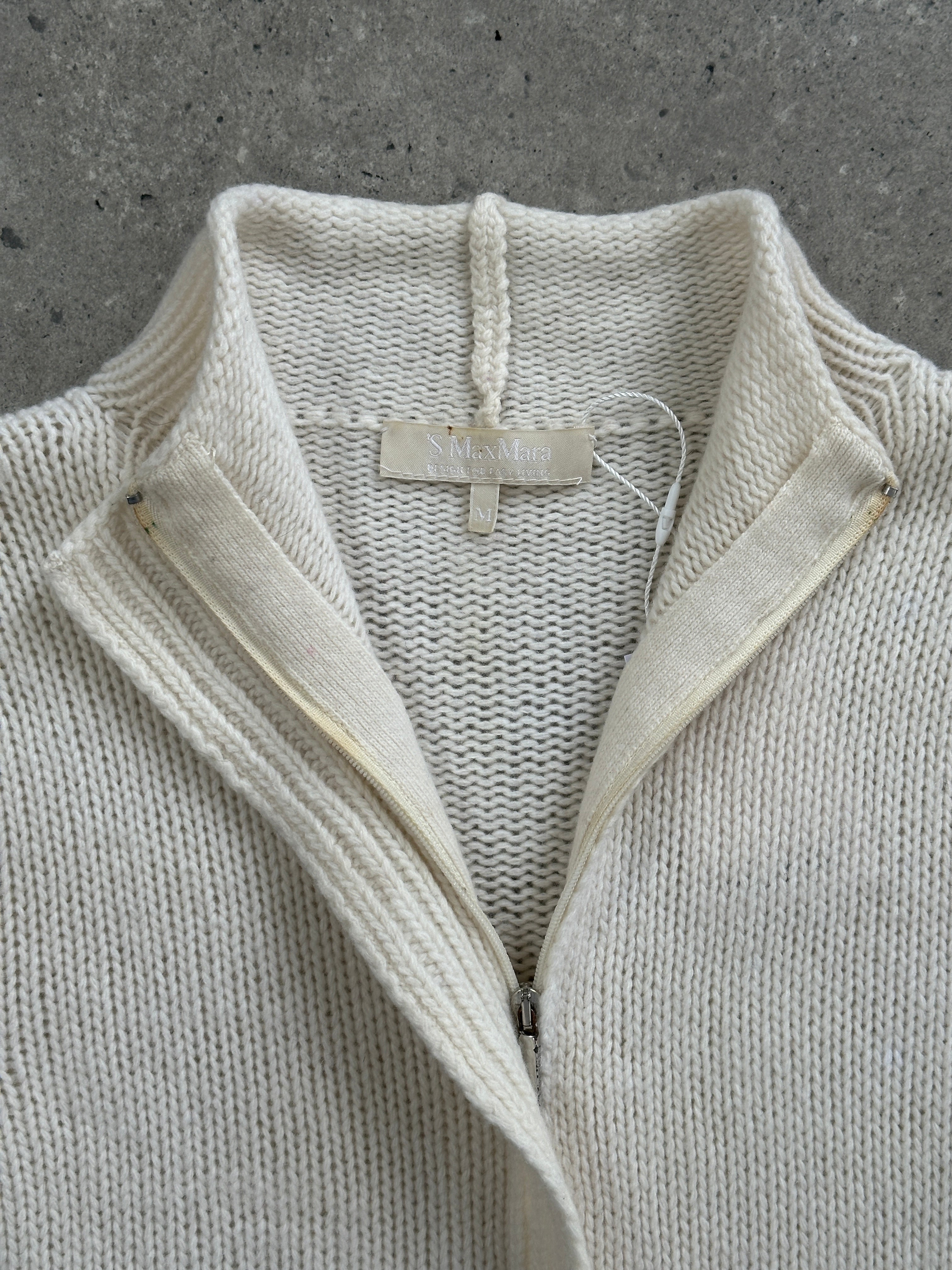 Max Mara S/M wool cashmere knitted double zip cardigan displayed on a hanger, showcasing its soft texture and elegant design.