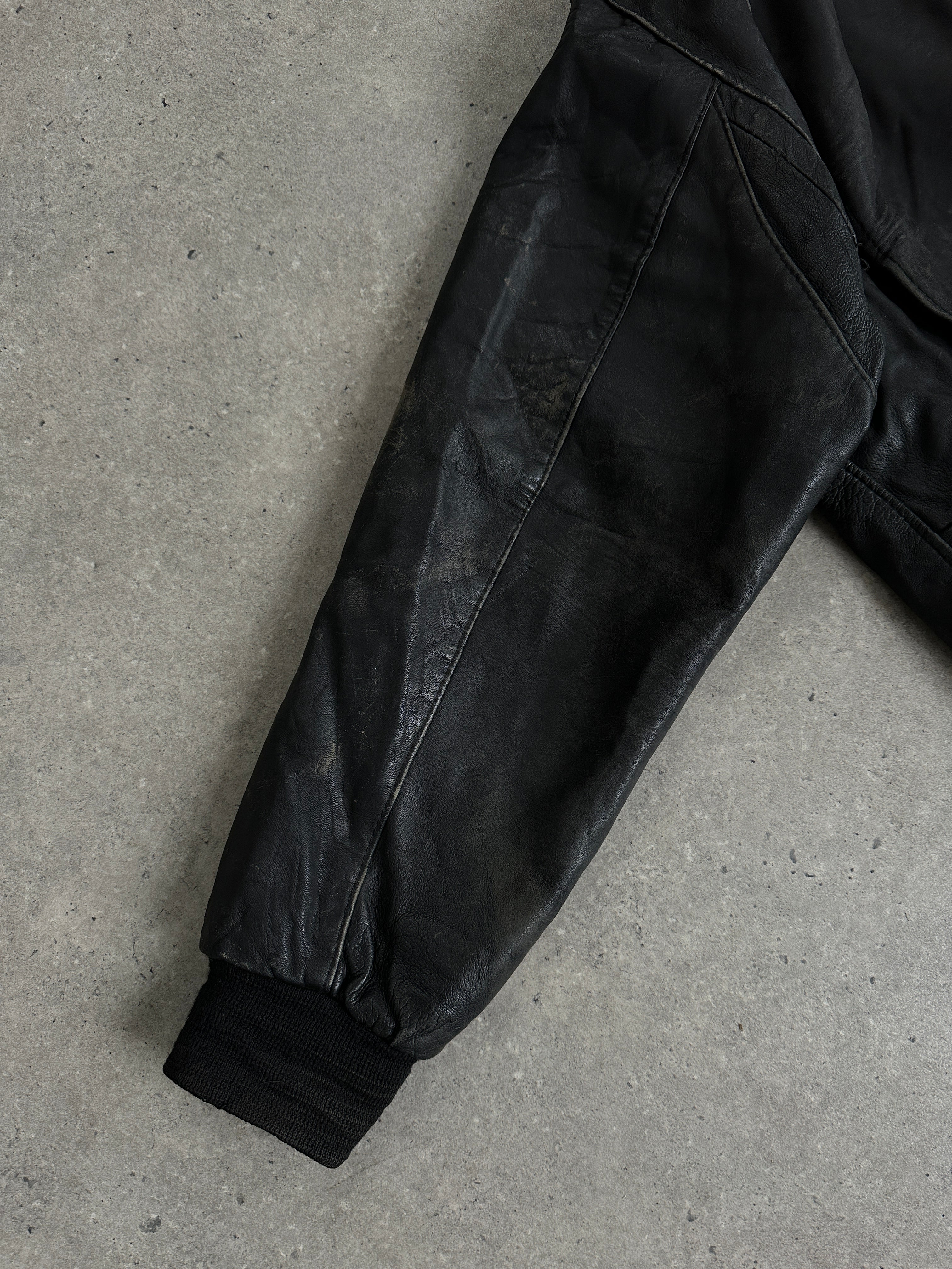 Vintage distressed leather bomber jacket in XL size, featuring rugged style and classic design.