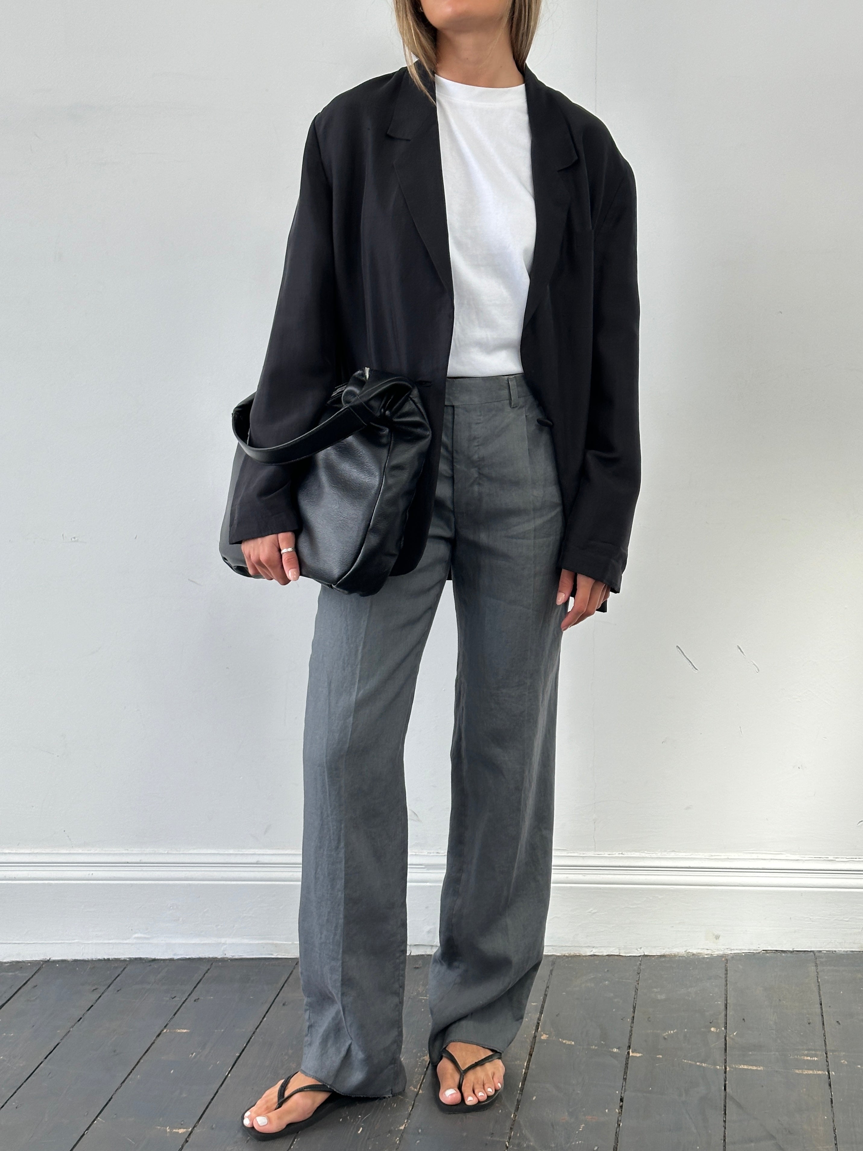 Vintage Italian vintage linen straight leg trousers with mid waist and pleats, shown in a light fabric and W30 size.