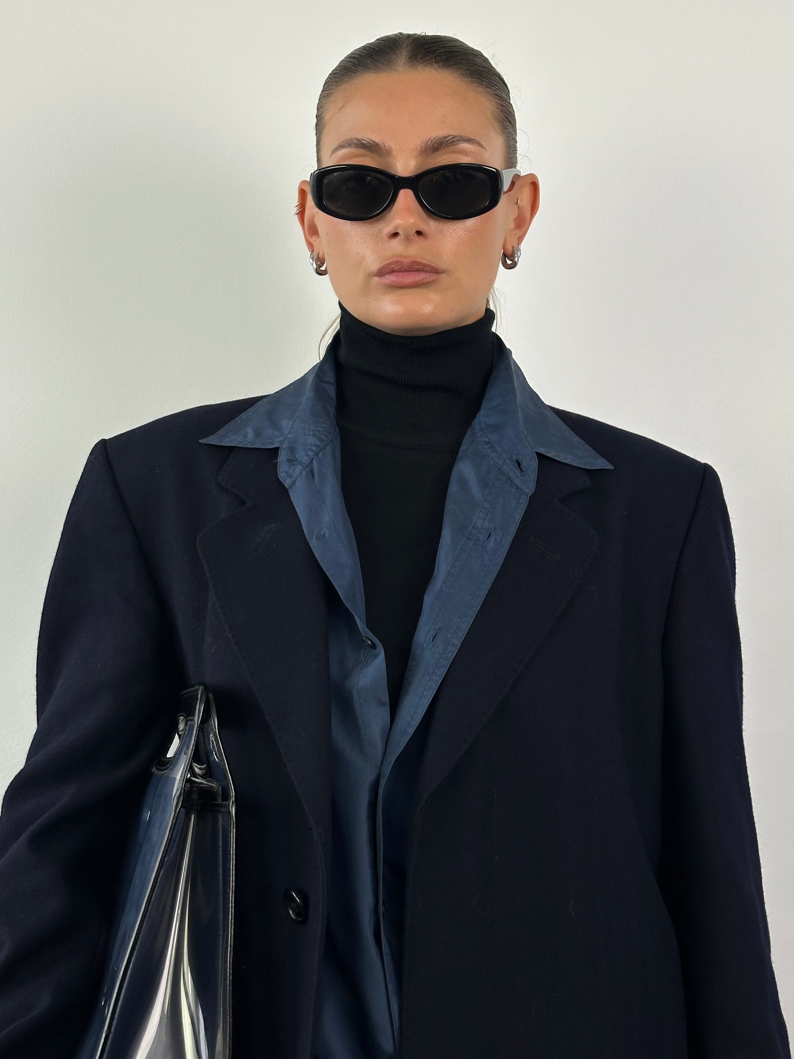 Christian Dior XL wool coat with concealed placket, stylish and warm, shown in a natural pose highlighting the tailored design.
