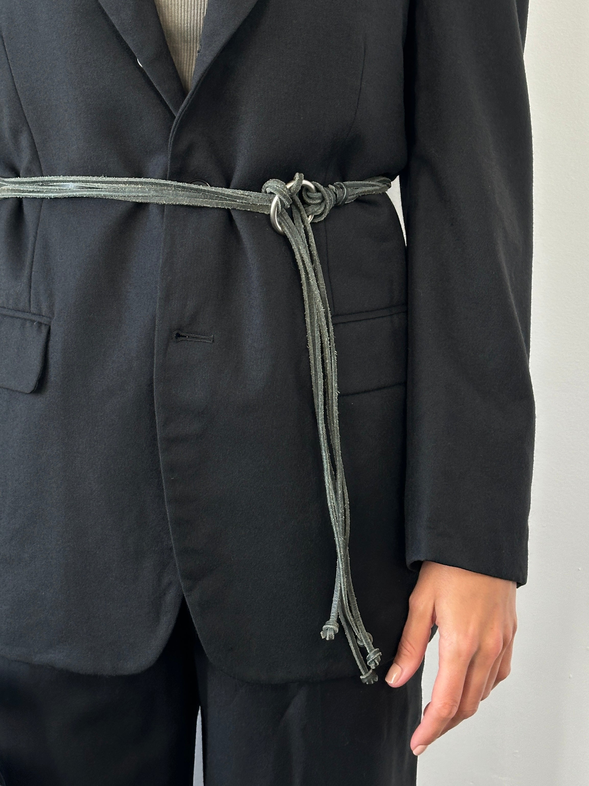 Vintage 1990s leather rope tassel belt with one size adjustable fit, featuring handcrafted leather and tassel details.